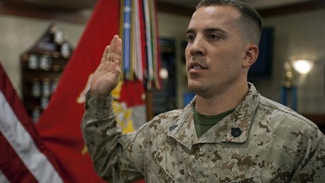 A Marine staff sgt. raises his right hand during a ceremony at an undisclosed location. Marine administrative message 160/15 announces the fiscal year 2015 Reserve Career Transition command visits will be conducted from April through July 2015, at designated commands.