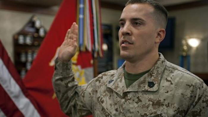 A Marine staff sgt. raises his right hand during a ceremony at an undisclosed location. Marine administrative message 160/15 announces the fiscal year 2015 Reserve Career Transition command visits will be conducted from April through July 2015, at designated commands.