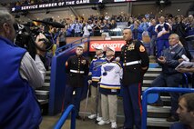Lloyd, left, and Bill Rupp are honored as the USO Service Members of the game during a St. Louis Blues hockey game March 30 at Scott Trade Center in St. Louis. The twin brothers enlisted in 1942 into the Marine Corps and served throughout the Pacific. Lloyd was a rear gunner on a Douglas SBD dauntless dive bomber and Bill was an anti-aircraft gunner. Both served four years in the Marine Corps during WWII and settled back in St. Louis. SSgt. Derek Krause, right, is the Pool Program Specialist and Sgt. Cody Tubbs is the Operations Clerk for Recruiting Station St. Louis. 