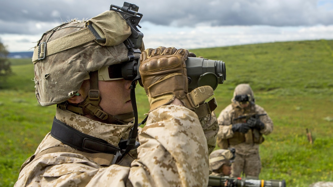 U.S. Marine Corps Cpl. Andrew Smoker, an infantry assaultman with Special-Purpose Marine Air-Ground Task Force Crisis Response-Africa, looks through binoculars to get eyes on a target down-range in Sierra Del Retin, Spain, March 24, 2015. Marines with SPMAGTF-CR-AF utilized the Spanish Marines’ training site to conduct several live-fire training exercises using a variety of weapon systems to include the AT-4, M240B machine gun, and M67 grenade.