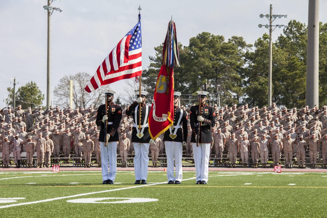 U.S. Marines render honors as the Marine Corps Color Guard presents the colors during a Battle Color Ceremony at Liversedge Field, Camp Lejeune, N.C., March 24, 2015. The ceremony featured the Drum and Bugle Corps, the Silent Drill Platoon and the Marine Corps Color Guard. (U.S. Marine Corps photo by Cpl. Carolyn P. Pichardo, MCI-East Combat Camera/Released)