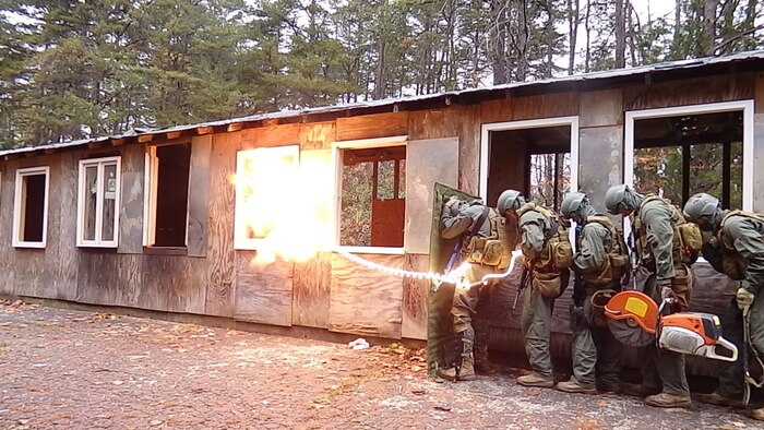 Marine students at the Methods of Entry School brace as explosives go off to breach a door during a test exercise at the Goettge Demolition Range in this undated photo.