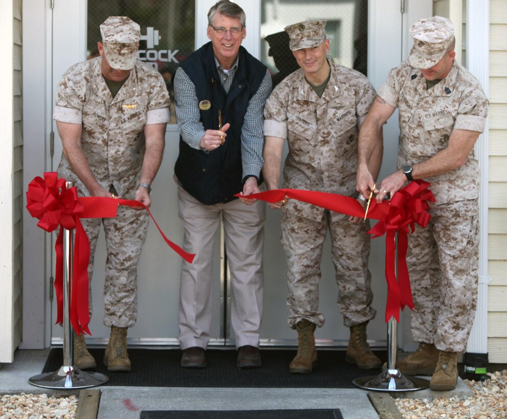 Lt. Col. Travis L. Powers, left, Mike Largent, center left, Col. Chris Pappas III, center right, and Sgt. Maj. Benjamin Pangborn, right, cut a ribbon at the grand opening of the Hancock Gym at Marine Corps Air Station Cherry Point, N.C., March 24, 2015. The recently renovated facility features state of the art gym equipment and hydrating systems. The facility is open to all Cherry Point residents to include retirees and Department of Defense employees. The facility is one of three projects Marine Corps Community Service is working on to provide the authorized patrons with ways to become and stay physically fit.  Powers is the airfield operations officer with Cherry Point. Mike Largent is the CEO of Marine Corps Community Services at Cherry Point. Pappas is the Cherry Point commanding officer, and Pangborn is the air station sergeant major.