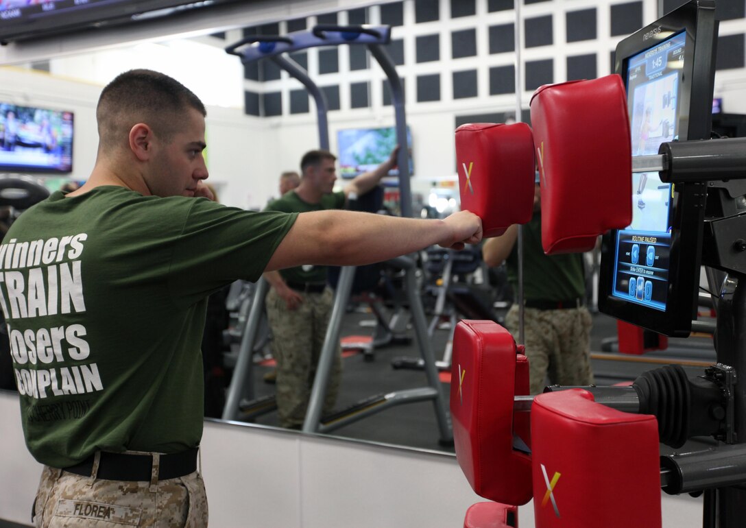 Sgt. Mitchell Florea punches the Nexersys at the Hancock Gym at Marine Corps Air Station Cherry Point, N.C., March 24, 2015. The Nexersys is a high-intensity interval training program that focuses on a variety of training to include core, sparring, cardio and strike training. The recently renovated gym features more than 70 new pieces of equipment, 13 new televisions and a hydrating station for patrons. The facility is open to all authorized patrons. Florea is an aircraft electronic countermeasures system technician with the Center of Naval Aviation Technical Training at Cherry Point.