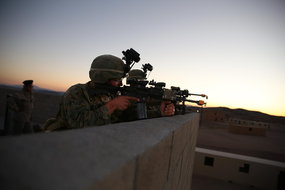 2nd Lt. Brett Woolard, student, Infantry Officers Course 2-15, posts security atop a building during exercise Talon Reach V at Range 220, March 27, 2015. Talon Reach is a culminating exercise that reinforces Marine Air Ground Task Force operations, introduces air assault planning considerations while leveraging innovative technology. (Official Marine Corps photo by Lance Cpl. Thomas Mudd/ Released)