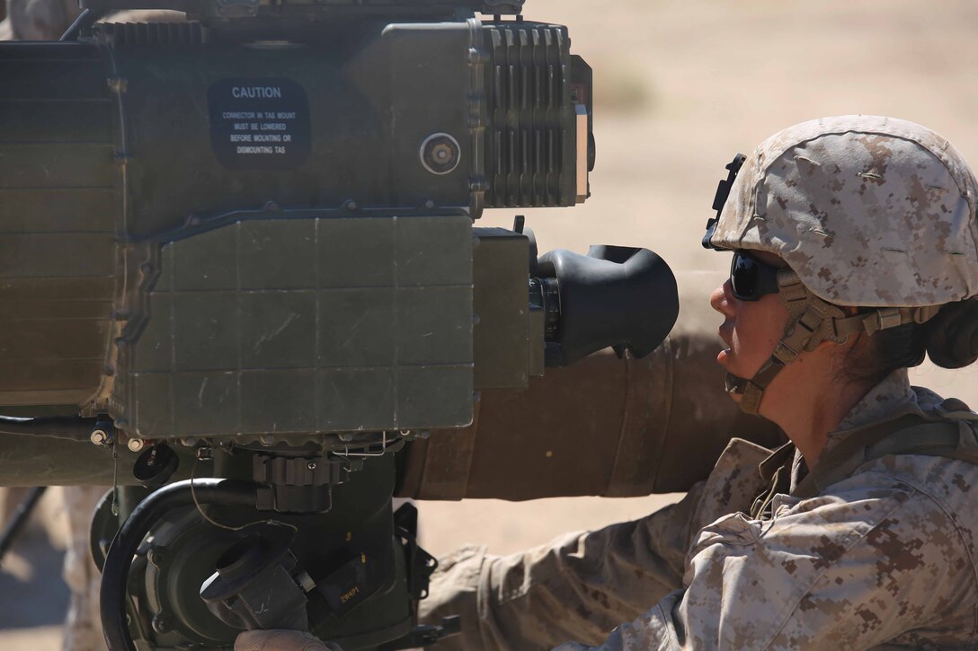 Sgt. Debra Riddle, anti-tank missileman, Anti-Armor Section, Weapons Company, Ground Combat Element Integrated Task Force, sights in on targets using an M41A4 Saber missile launcher during a Marine Corps Operational Test and Evaluation Activity assessment at Range 110, Marine Corps Air Ground Combat Center Twentynine Palms, California, March 28, 2015. From October 2014 to July 2015, the GCEITF will conduct individual and collective level skills training in designated ground combat arms occupational specialties in order to facilitate the standards-based assessment of the physical performance of Marines in a simulated operating environment performing specific ground combat arms tasks. (U.S. Marine Corps photo by Cpl. Paul S. Martinez/Released) 