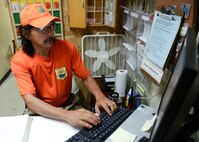 Maurice Ibanez, 36th Civil Engineer Squadron Environmental Flight volunteer conservation officer, verifies the credentials of people participating in a conservation program March 28, 2015, at Northwest Field, Guam. Another way VCOs help protect Guam’s environment is by participating in reforestation site maintenance projects where they clear rocks and invasive plant species interfering with the growth of indigenous vegetation. (U.S. Air Force photo by Senior Airman Katrina M. Brisbin/Released)