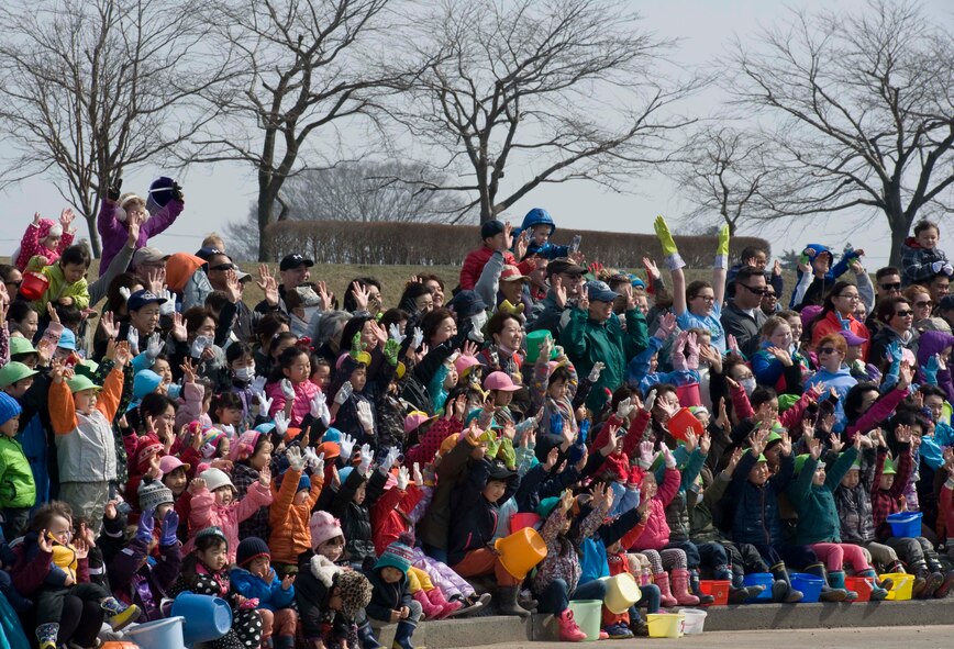 Members of Misawa Air Base and the local community pose for a group photo during the 18th Annual Baby Salmon Release at the Oirase Salmon Park, Japan, March 28, 2015. Participants included members from Misawa Girl Scout Troop 33, local Japanese schools, the 35th Civil Engineer Squadron and the Oirase Town office. (U.S. Air Force photo by Airman 1st Class Jordyn Rucker/Released)