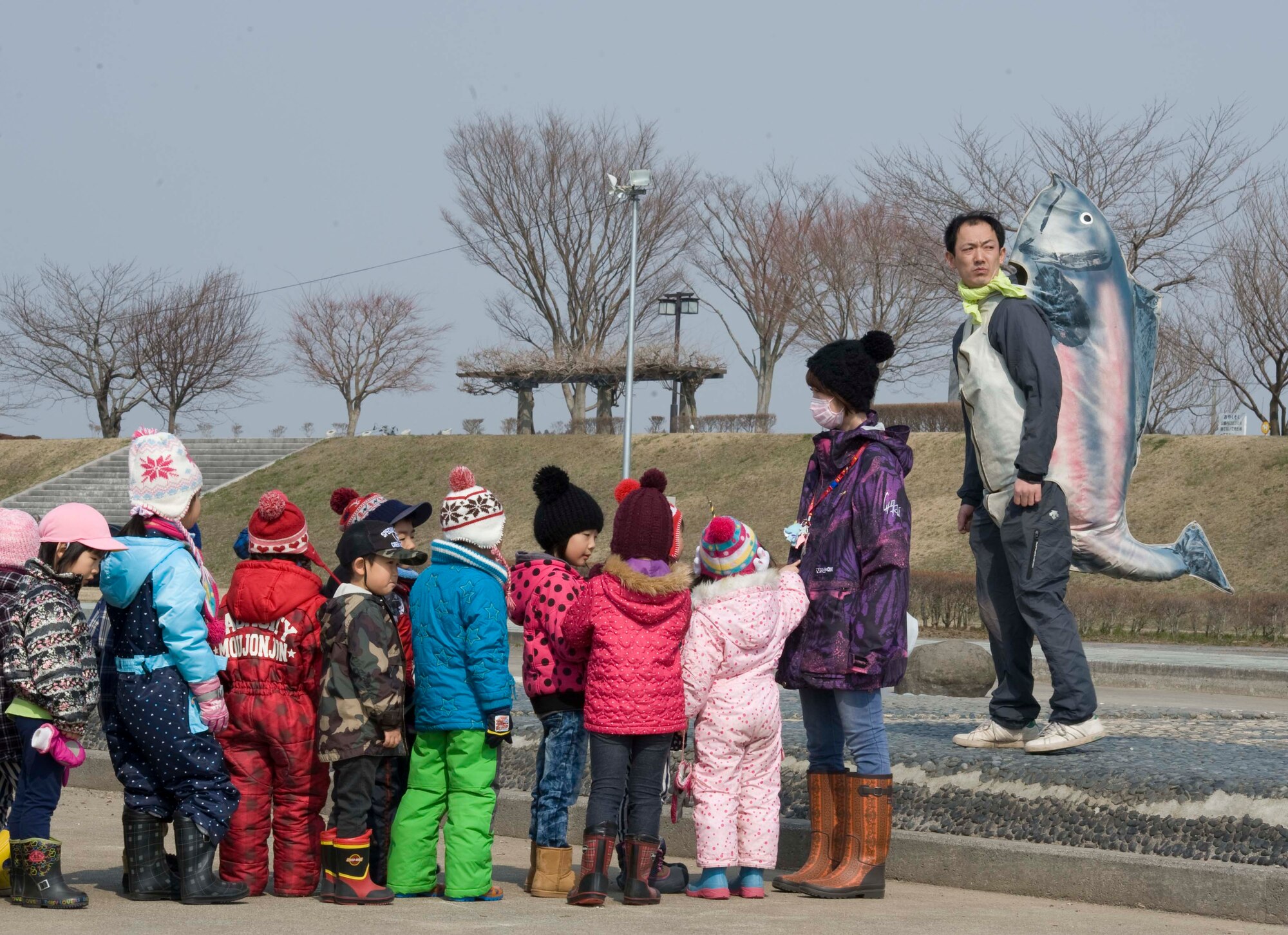 Japanese children wait for the start of the 17th Annual Baby Salmon Release at the Oirase Salmon Park, Japan, March 28, 2015. Children from more than 10 local pre-school and kindergarten classes participated in the event which released over 400,000 baby salmon. (U.S. Air Force photo by Airman 1st Class Jordyn Rucker/Released)