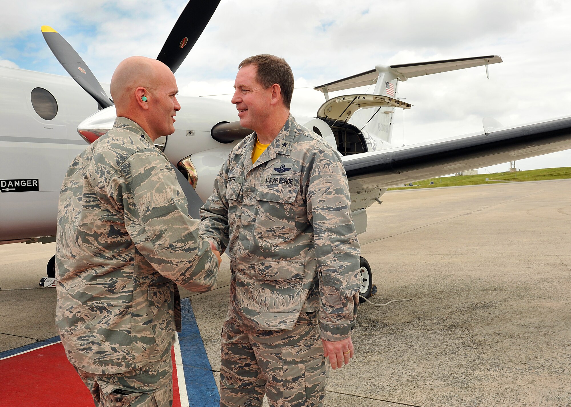 U.S. Air Force Lt. Gen. Carlton D. Everhart II, 18th Air Force commander, and Brig. Gen. James Hecker, 18th Wing commander, shake hands during a visit on Kadena Air Base, Japan, March 27, 2015. While on Kadena, Everhart and Maj. Gen. Frederick Martin, U.S. Air Force Expeditionary Center commander, toured the passenger terminal, the air terminal operations center, the maintenance operations center, the air freight terminal and the maintenance facility to interact with Airmen and develop a better sense of the mission at Kadena. (U.S. Air Force photo by Naoto Anazawa)
