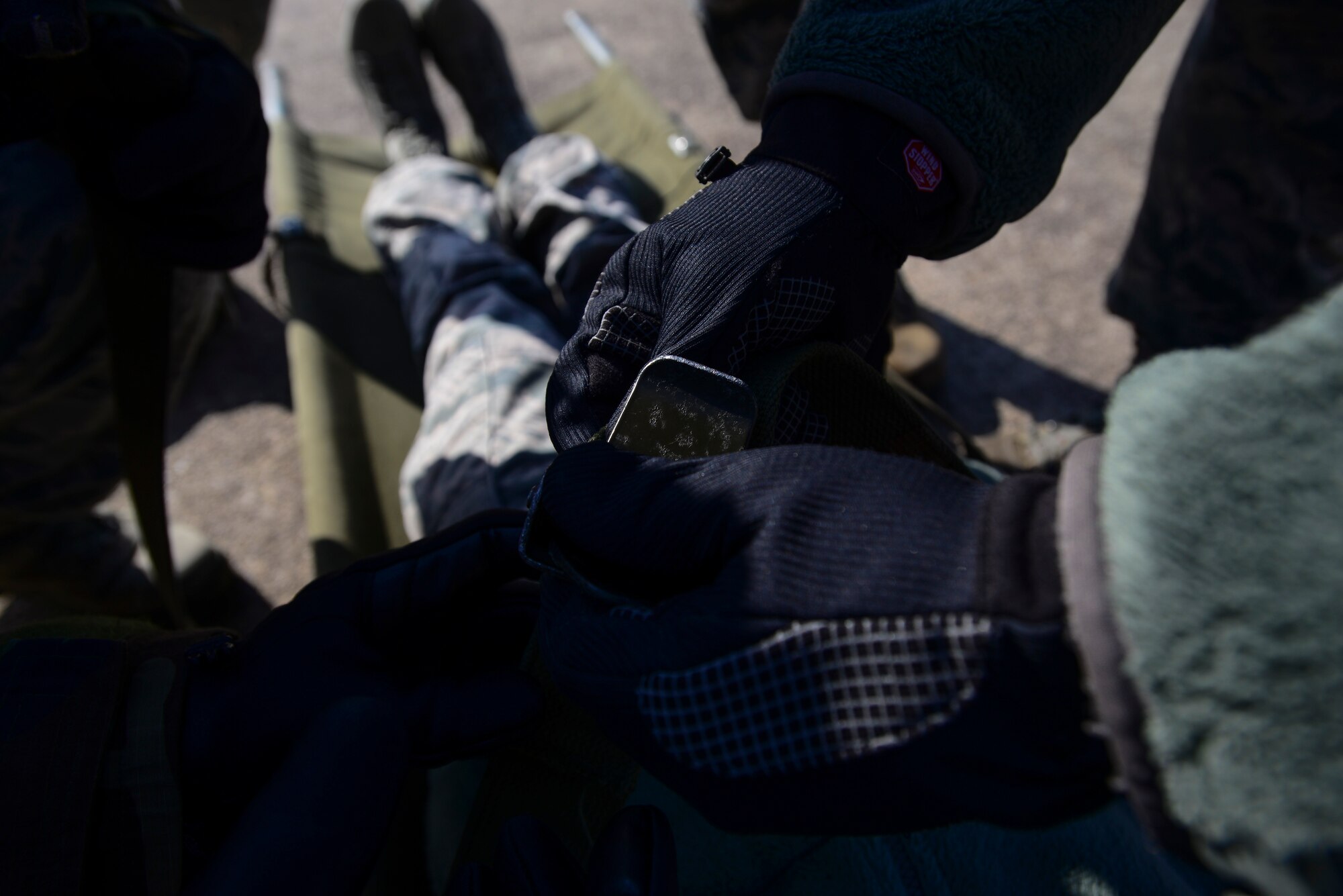 Airmen tighten the straps on a litter before lifting carrying the Airmen onto the aircraft during a medical evacuation airlift training scenario March 4, 2015, at Osan Air Base, Republic of Korea. The Beverly Midnight 15-01 exercise is designed to test American forces in the ROK on their mission readiness in the event of an emergency or wartime environment. (U.S. Air Force photo by Senior Airman David Owsianka)