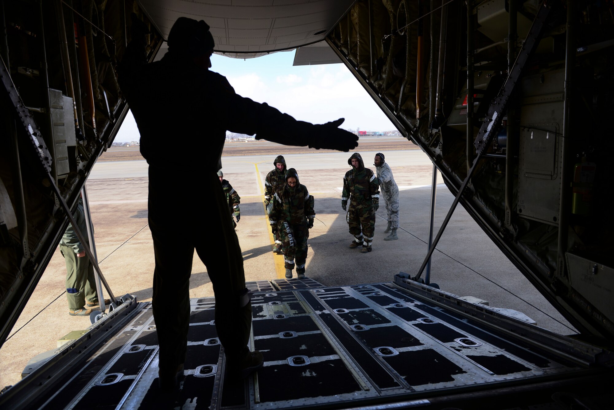 Capt. Weber Munsayac, 18th Air Medical Evacuation Squadron flight nurse, Kadena Air Base, Japan, directs Airmen on where to take the litter during a medical evacuation airlift training scenario March 4, 2015, at Osan Air Base, Republic of Korea. The Beverly Midnight 15-01 exercise is designed to test American forces in the ROK on their mission readiness in the event of an emergency or wartime environment. (U.S. Air Force photo by Senior Airman David Owsianka)