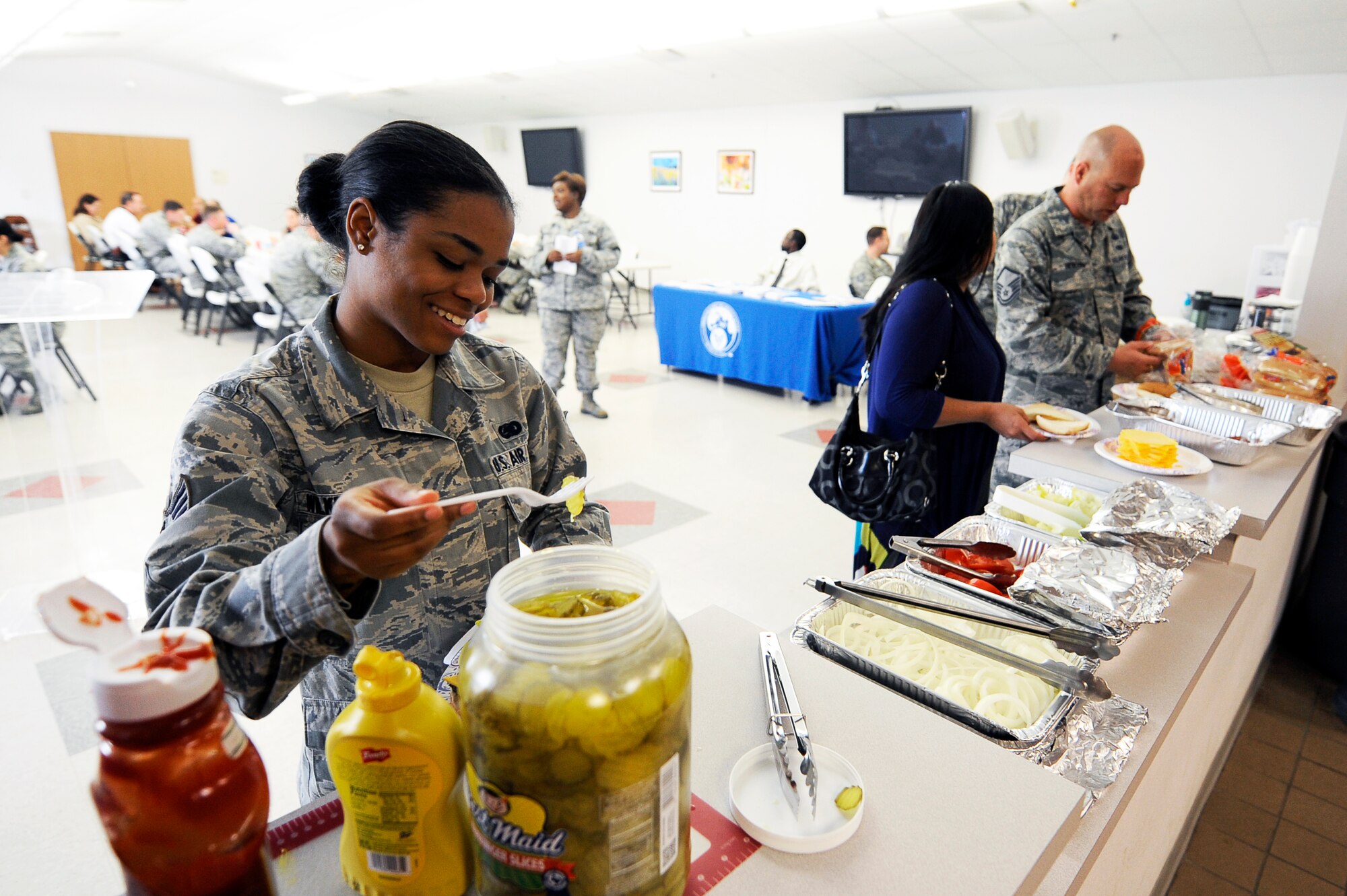 GOODFELLOW AIR FORCE BASE, Texas – Senior Airman Briana N. Wilkerson, 17th Logistics Readiness Squadron contingency plans technician, prepares a plate at the Air Force Assistance Fund cookout event at the Taylor Chapel March 30.  The event was held to help stimulate contributions at the midway point of the campaign. (U.S. Air Force photo/Tech. Sgt. Austin Knox)      