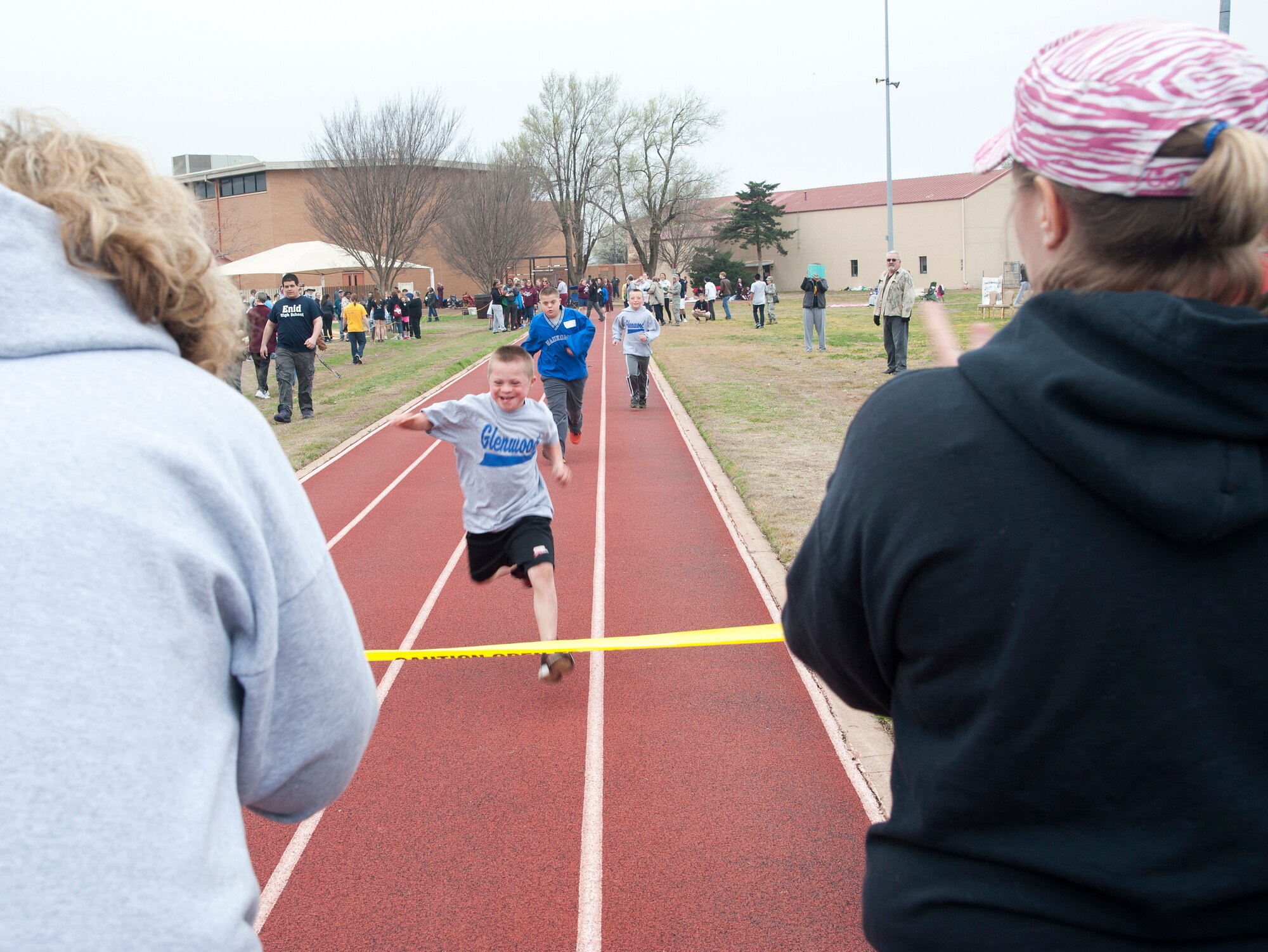 VANCE AIR FORCE BASE, Okla. -- Spectators cheer on Olympians running the 50-meter dash during the 2015 Special Olympics at the Vance track March 25. This is the 26th year that Vance hosted the Special Olympics. (U.S. Air Force photo/Staff Sgt. Nancy Falcon)