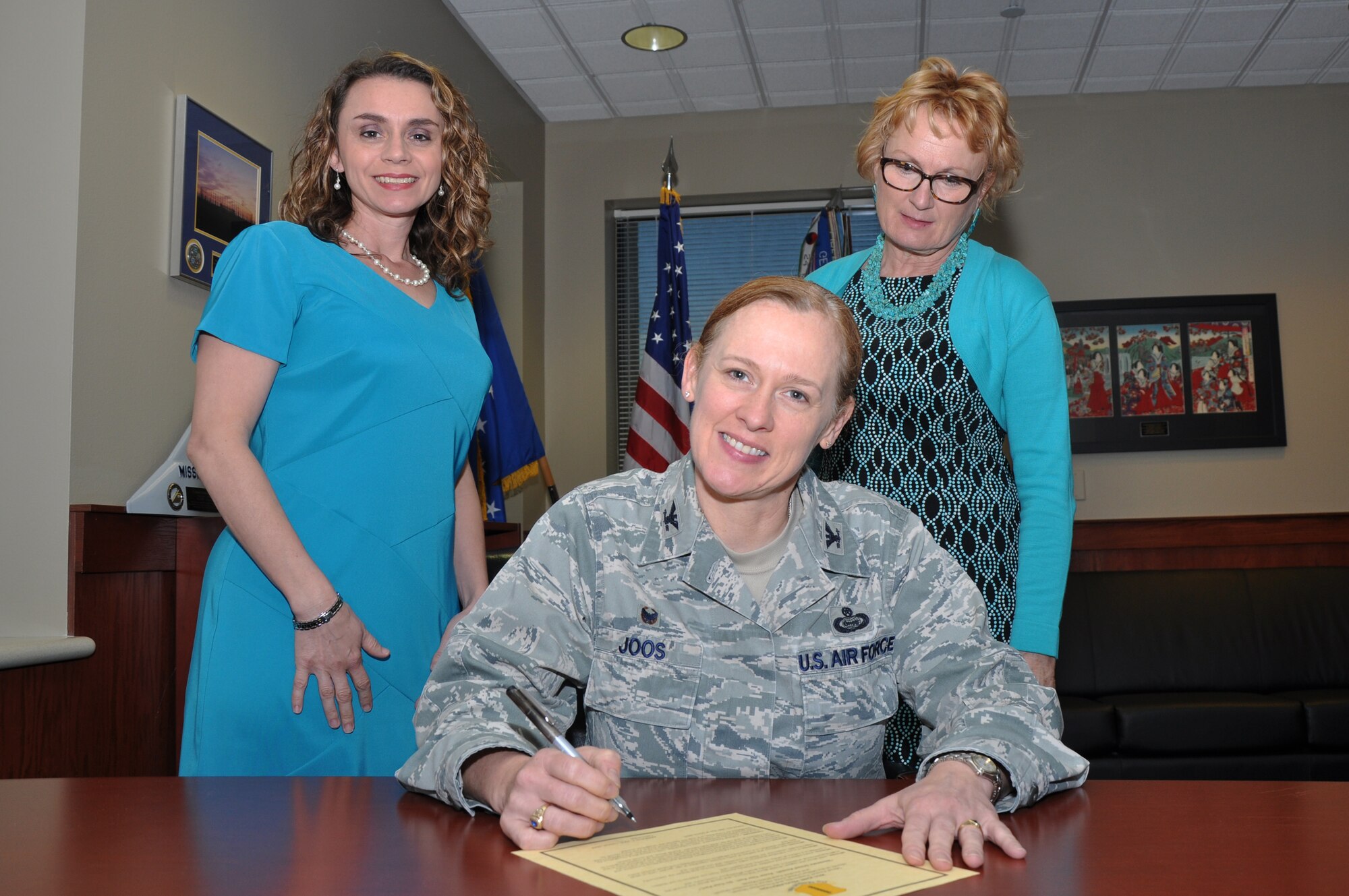 GOODFELLOW AIR FORCE ABSE, Texas - Col. Kimberlee P. Joos, 17th Training Wing Commander, signs the April 2015 Joint Proclamation in the Norma Brown Building March 26. April marks the start of Sexual Assault Awareness and Prevention Month, Month of the Military Child, Child Abuse Prevention Month and Alcohol Awareness Month. (U.S. Air Force photo/ Senior Airman Joshua Edwards)
