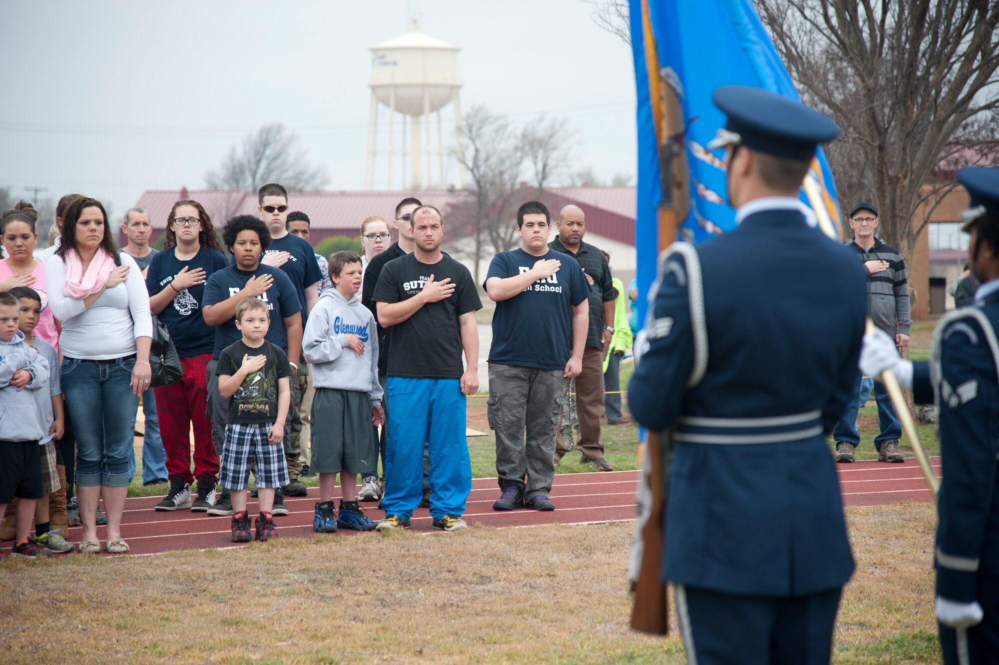 VANCE AIR FORCE BASE, Okla. -- Members from Vance Air Force Base and Area 6 Special Olympics teams stand during a presentation of the colors and the singing of the national anthem during the 2015 Special Olympics at the Vance track March 25. This is the 26th year that Vance hosted the Special Olympics. (U.S. Air Force photo/Staff Sgt. Nancy Falcon)