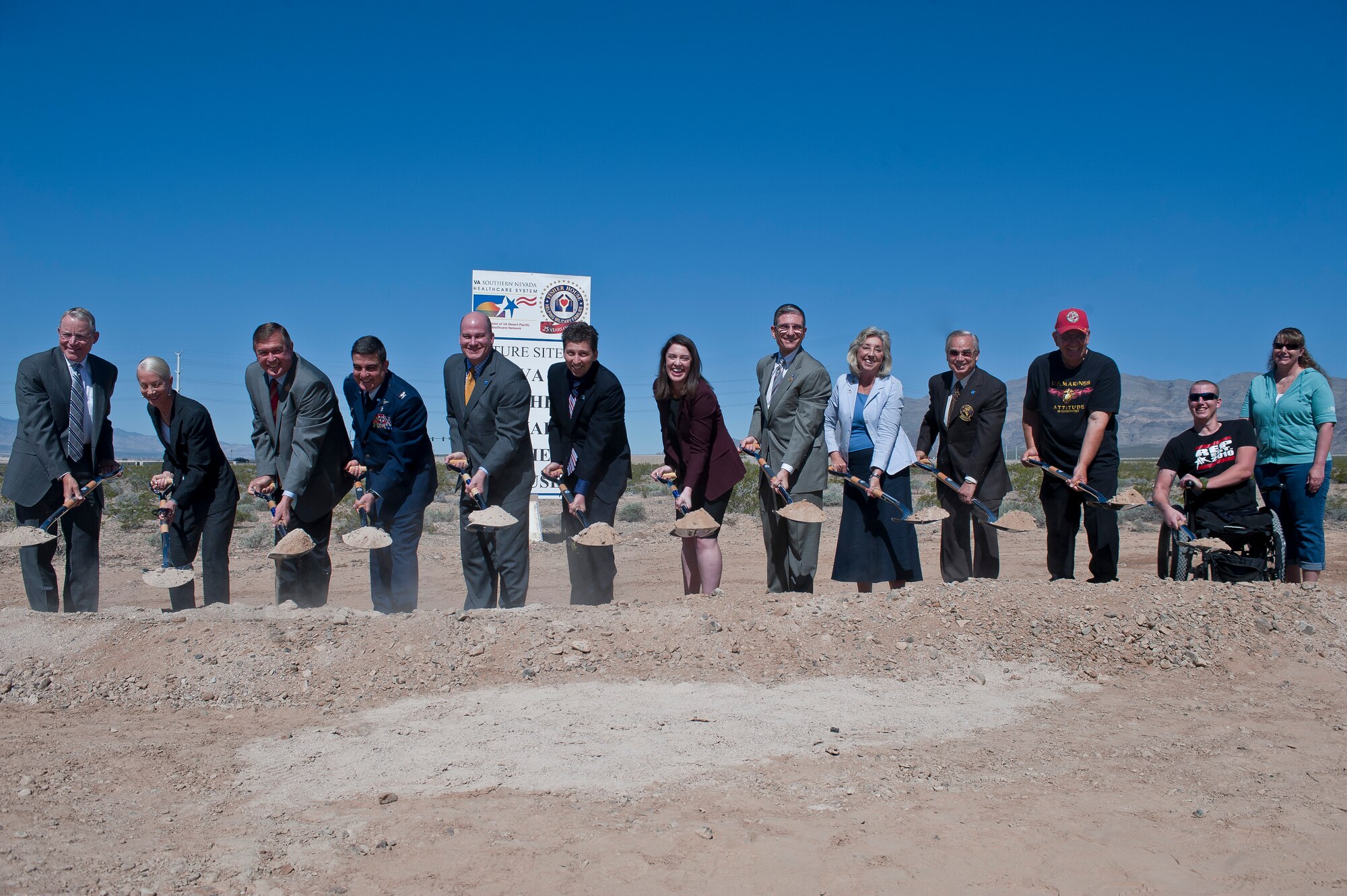 Col. (Dr.) Guillermo Tellez (fourth from left), 99th Medical Group commander, joins other distinguished guests in the ceremonial dig at the Fisher House ground breaking ceremony at the Department of Veterans Affairs Southern Nevada Healthcare System campus in Las Vegas March 27, 2015. The Fisher House Foundation is best known for a network of comfort homes where military and veterans’ families can stay at no cost while a loved one is receiving treatment at a VA hospital or military treatment facility. (U.S. Air Force photo by Staff Sgt. Siuta B. Ika)