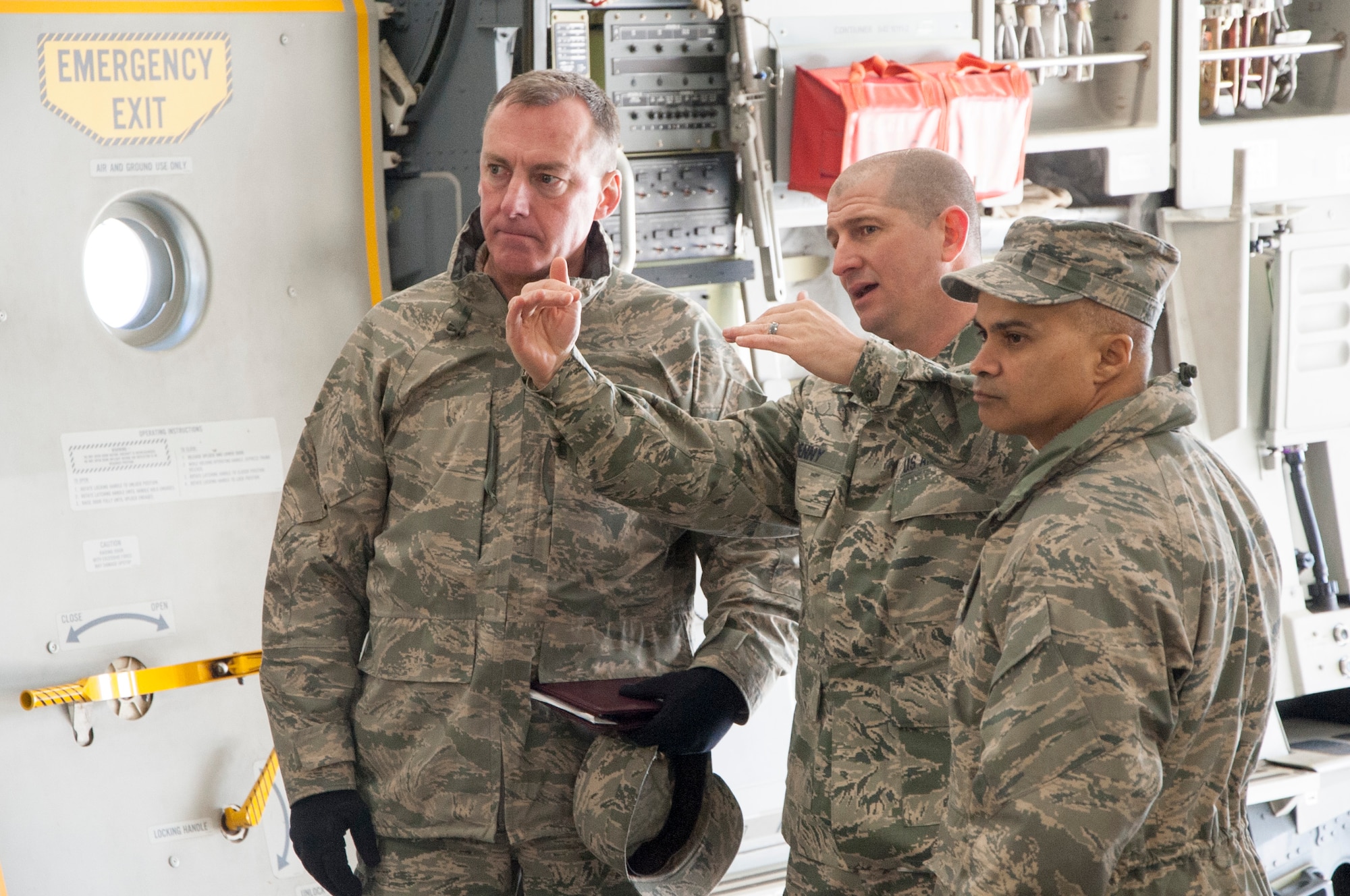 Senior Master Sgt. Brian Denny, Air Force Mortuary Affairs Operations superintendent (center), briefs Col. Daniel F. Merry, AFMAO commander, and Chief Master Sgt. Rabin Ramsook, AFMAO chief enlisted manager, about some of the behind-the-scene details during a dignified transfer divert exercise March 19, 2015, at New Castle Air National Guard Base, Del. The exercise involved 60 total force members executing a contingency DT plan at an alternate location. (U.S. Air Force photo/Senior Airman Jared Duhon) 