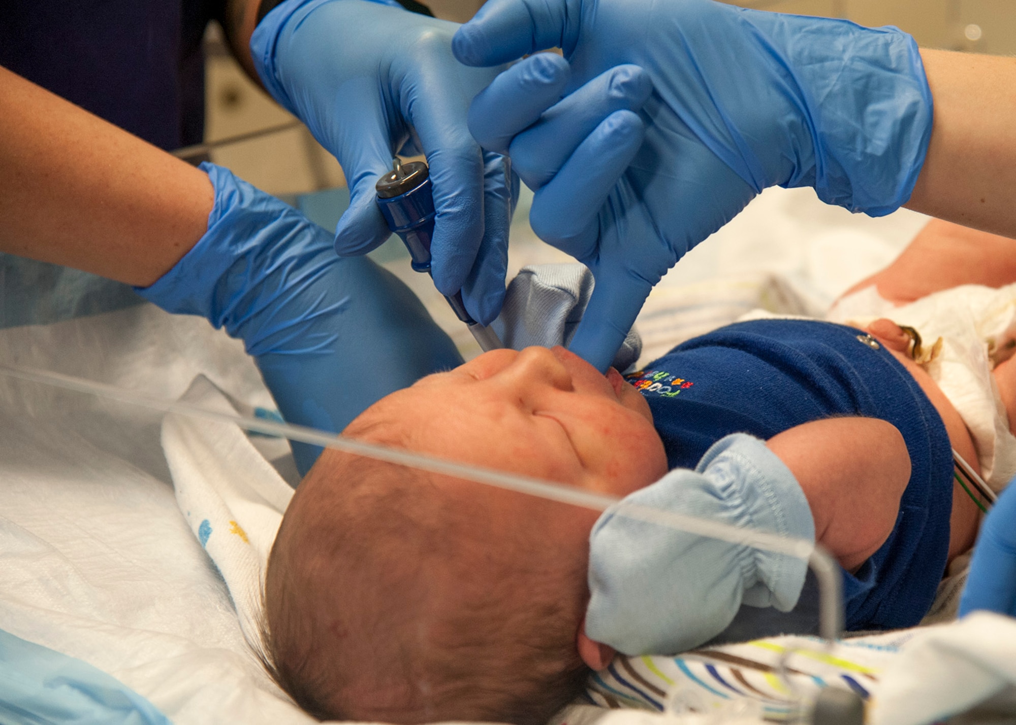 Labor and delivery technicians with the 96th Medical Group’s Maternal Child (Labor and Delivery) Flight, keep an inpatient baby calm during a temperature check, Feb. 24 at Eglin Hospital on Eglin Air Force Base, Fla. The labor and delivery unit, part of the 96th Inpatient Squadron, provides care for all of Eglin’s newborn inpatients. They delivered 764 babies in 2014. (U.S. Air Force photo/Ilka Cole)