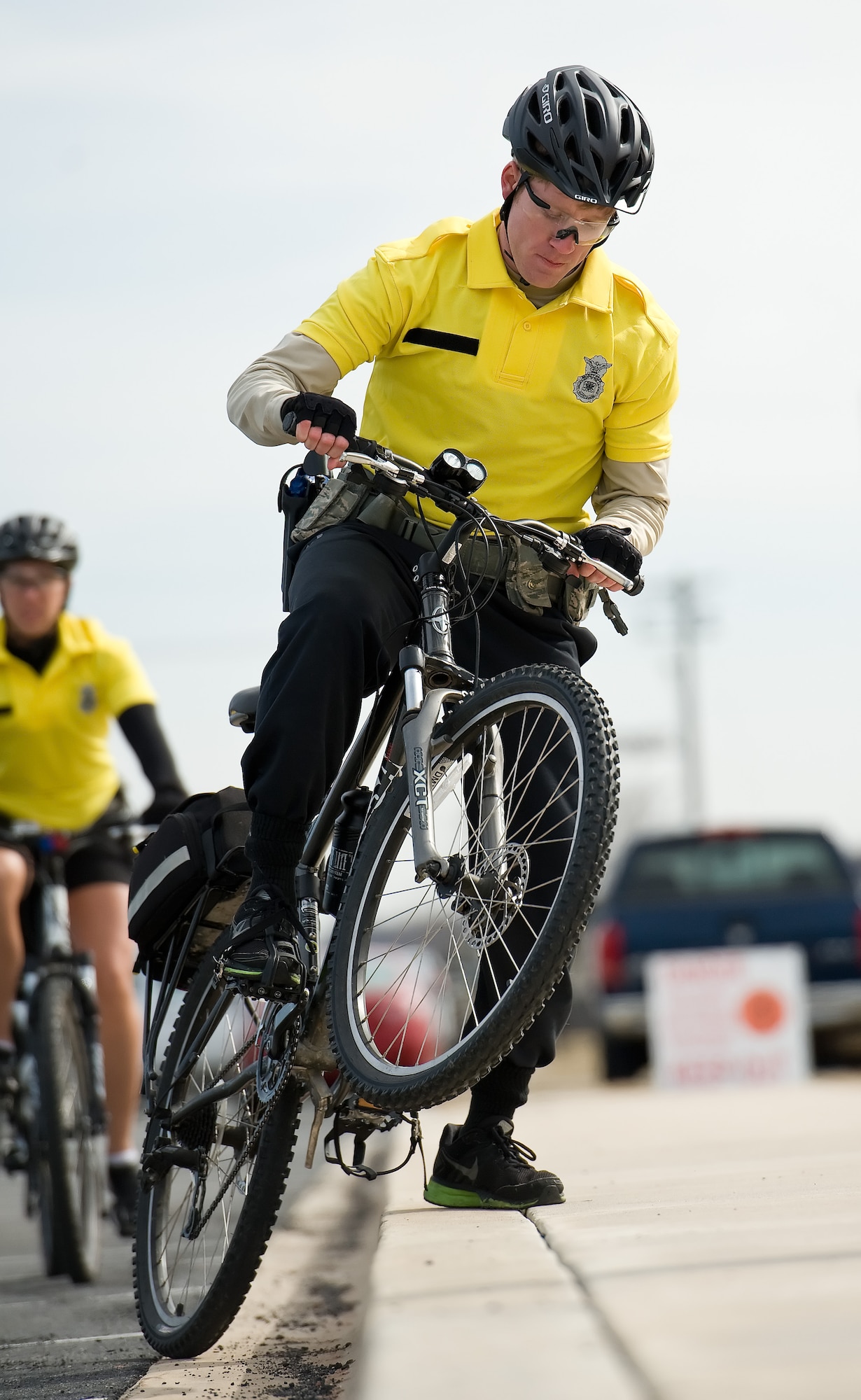 Senior Airman Jordan Hucks, 436th Security Forces Squadron response force leader practices riding techniques used to place his mountain bike up on a sidewalk from street level March 19, 2015, at Dover Air Force Base, Del. Hucks and other bike patrol members practiced riding techniques for properly ascending from and descending to street level. (U.S. Air Force photo/Roland Balik)