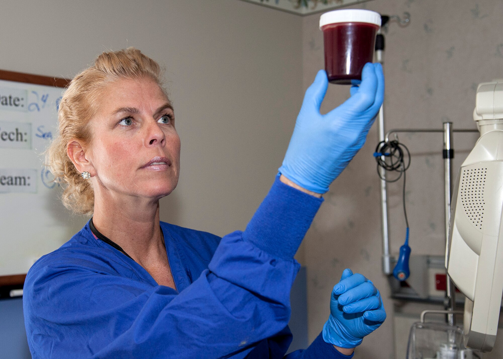 Staci McCoy, a licensed practical nurse with the 96th Medical Group’s Inpatient Squadron’s Multi-Service Unit, measures drainage from a patient’s closed wound suctioning device, Feb. 24 at Eglin Hospital on Eglin Air Force Base, Fla. The nurses monitor output volumes for any indication of excessive or abnormal bleeding. The IPTS provides care for all of Eglin’s inpatients.  Approximately 380 – 450 patients are admitted to the MSU for post-surgical care each month. (U.S. Air Force photo/Ilka Cole) 