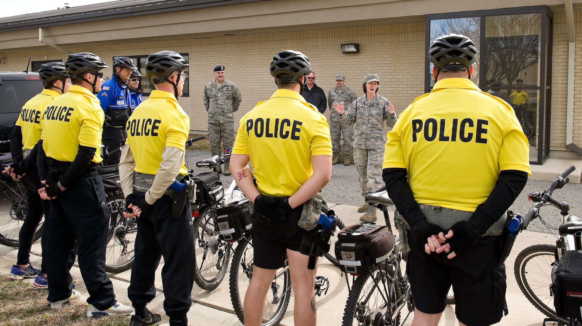 Colonel Lisa Pike, 436th Mission Support Group commander, talks to 436th Security Forces Squadron bike patrol members on their last day of training March 19, 2015, at Dover Air Force Base, Del. Seven 436th SFS members received police mountain bike patrol training March 16-19, 2015, by International Police Mountain Bike Association certified instructors from the Ocean City Police Department, Md. (U.S. Air Force photo/Roland Balik)