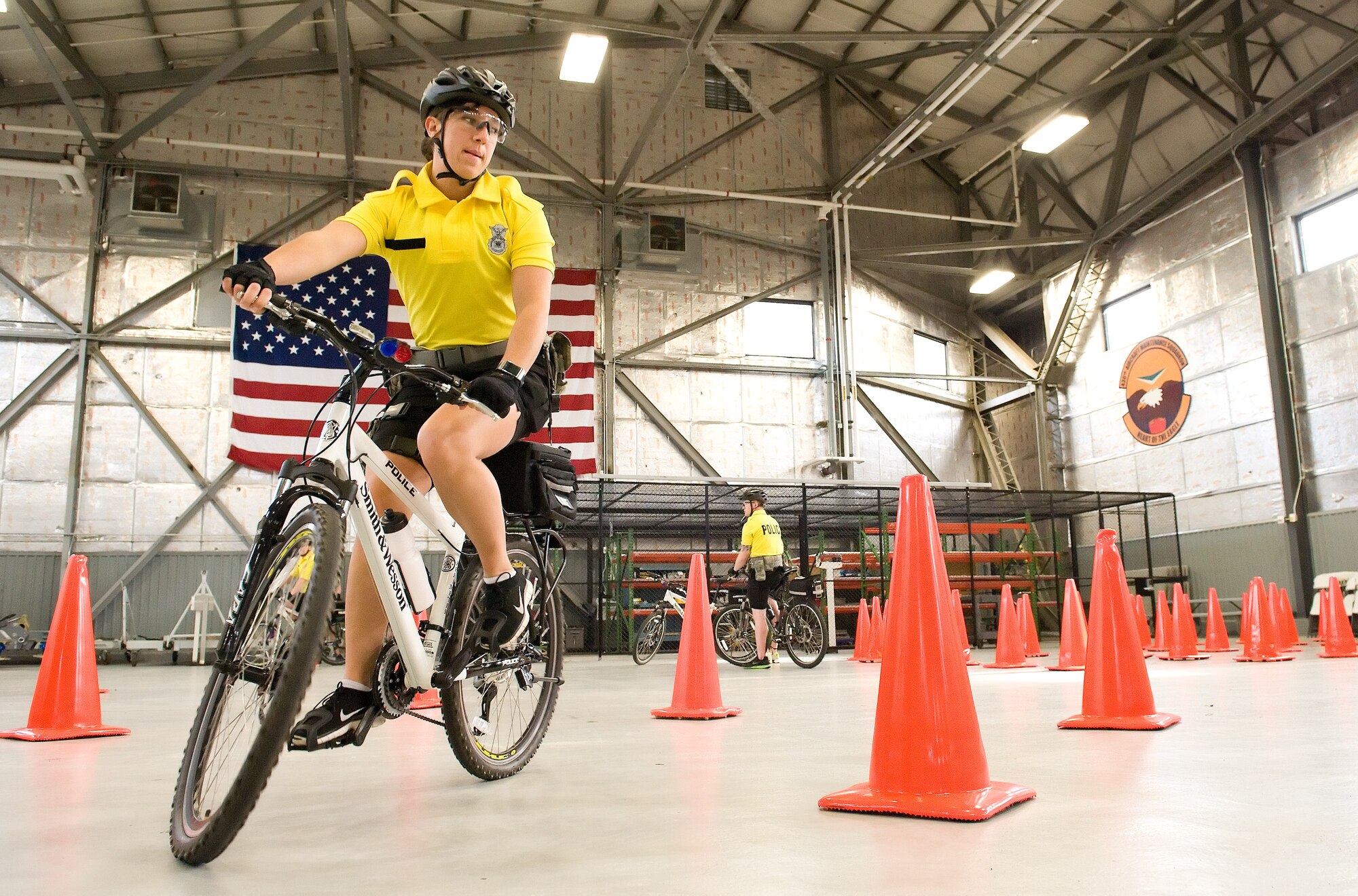 Senior Airman Angela Gaul, 436th Security Forces Squadron response force leader, practices maneuvering her mountain bike through an obstacle course at slow speed March 17, 2015, at Dover Air Force Base, Del. Gaul was one of seven 436th SFS members that received mountain bike patrol training March 16-19, 2015, by certified instructors from the Ocean City Police Department, Md. (U.S. Air Force photo/Roland Balik)