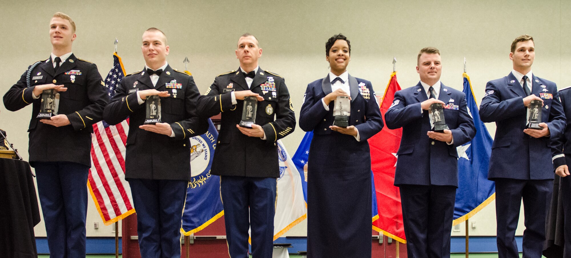 The Kentucky National Guard honored its Outstanding Soldiers and Airmen of the Year during a banquet held at the Kentucky Fair and Exposition Center in Louisville, Ky., March 14, 2105. Pictured from left to right are Army Spc. Christopher Jones, Army Staff Sgt. Jesse Mascoe, Army Sgt. 1st Class Jay Taheny, Air Force Master Sgt. Zakiya Taylor, Air Force Tech. Sgt. Don Yeats and Air Force Senior Airman William Willging. (U.S. Air National Guard photo by Senior Airman Joshua Horton)