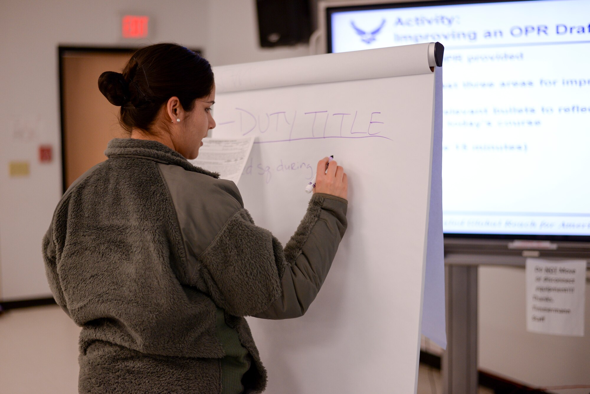 Second Lt. Lauren Alto, 60th Aerial Port Squadron air freight officer in-charge, Travis Air Force Base, Calif., corrects a performance bullet during the Air Mobility Command Flight Commander and Officer-in-Charge Leadership Development Program beta course at the Timmermann Center on Joint Base McGuire-Dix-Lakehurst, N.J., March 24, 2015. The course is a test to create a standardized training method company grade officers can attend to advance their skills as supervisors in the U.S. Air Force. (U.S. Air Force photo by Airman 1st Class Tara A. Williamson/Released)