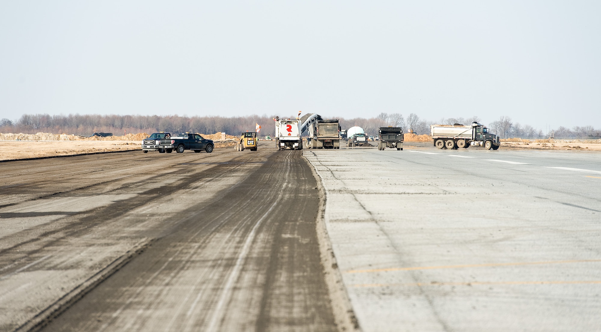 Contractors remove asphalt near the approach end of runway 01-19 March 9, 2015, at Dover Air Force Base, Del. This runway project is completely renovating runway 01-19. (U.S. Air Force photo by Roland Balik)