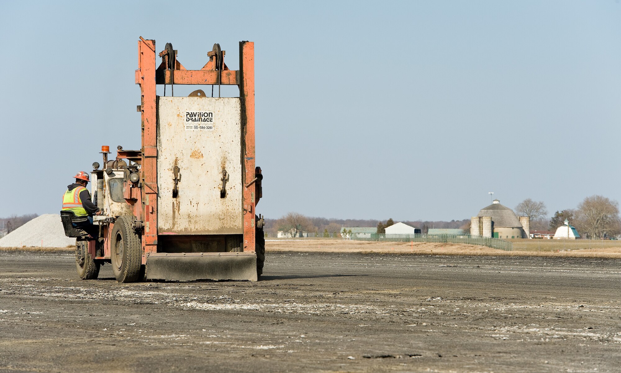 A contractor uses a piece of machinery to break up the runway near the approach end of runway 01-19 March 9, 2015, at Dover Air Force Base, Del. The runway renovation is expected to be completed in June 2016. (U.S. Air Force photo by Roland Balik)