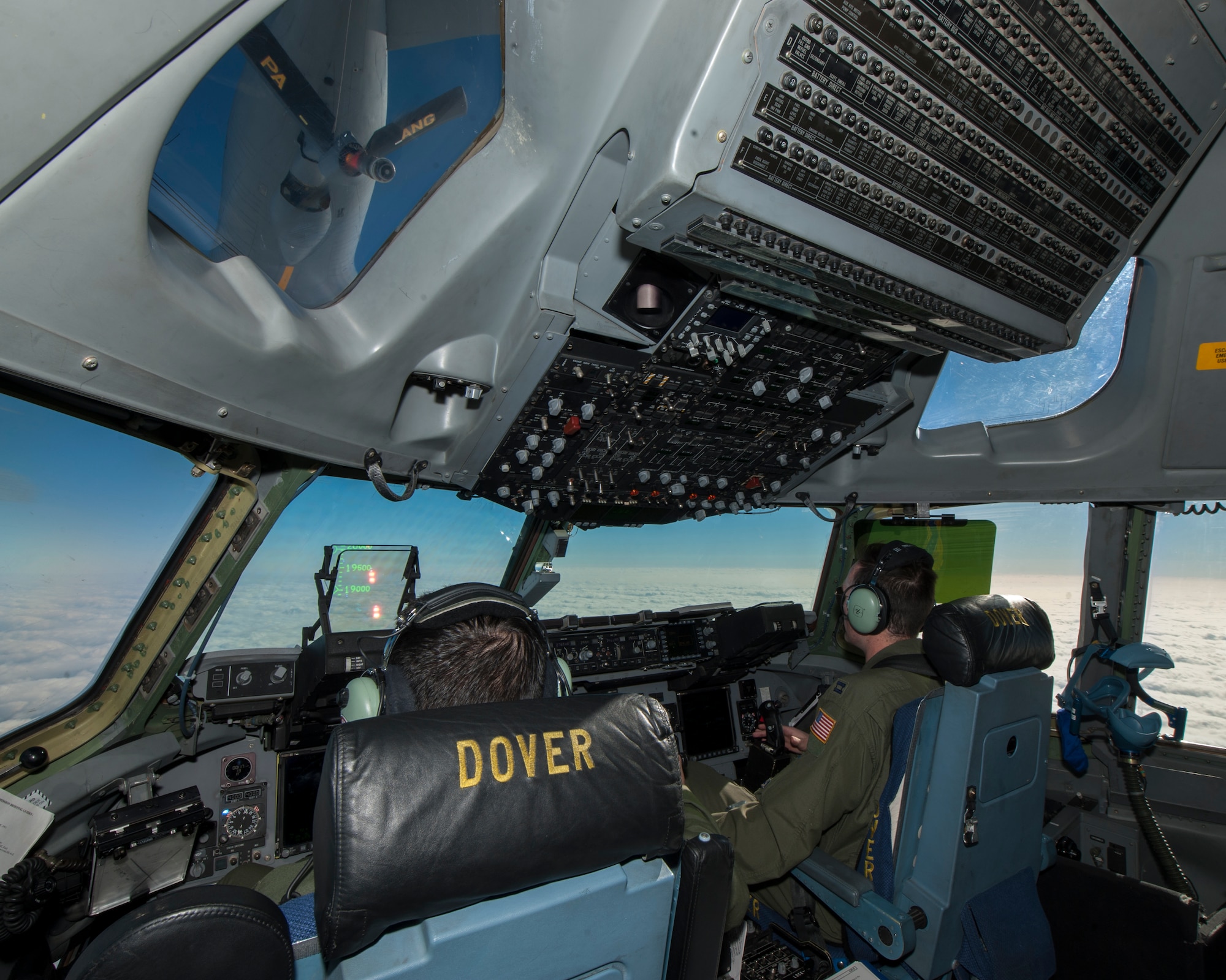 Capt. Ishan Avila, 3d Airlift Squadron pilot, left, and Capt. Justin Brozzetti, 3d AS squadron tactics chief, maneuver a C-17A Globemaster III during an aerial refueling training mission Nov. 20, 2014, out of Dover Air Force Base, Del. Team Dover’s C-17s will continue to be able to operate out of Dover AFB during runway construction. (U.S. Air Force photo/Airman 1st Class Zachary Cacicia)