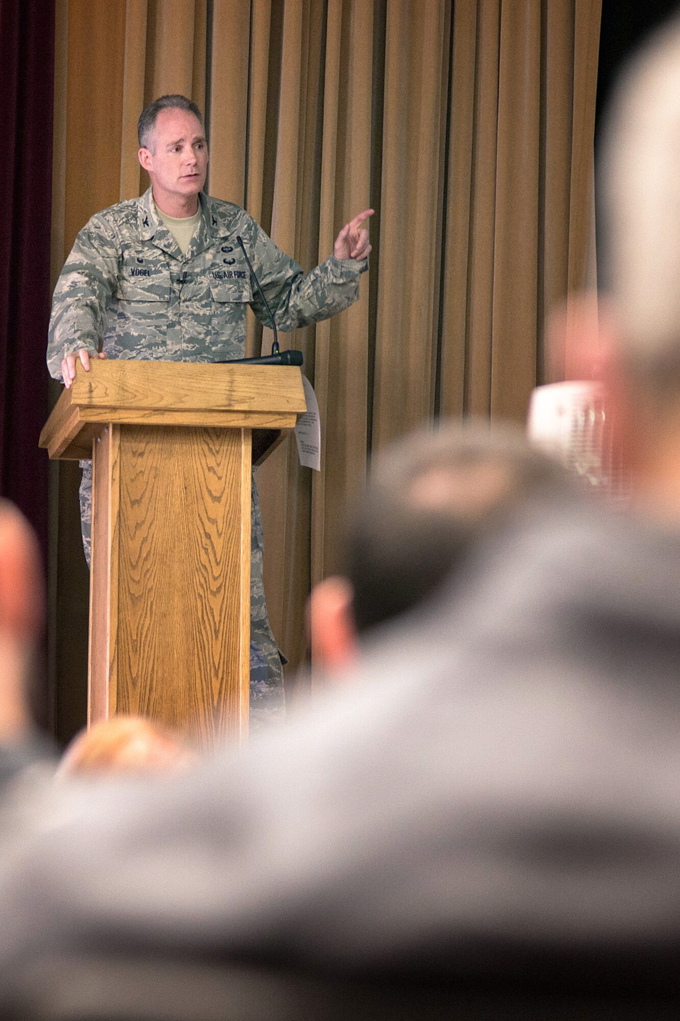 Col. Michael A. Vogel, 66th Air Base Group commander, speaks with members of the workforce during an ABG commander’s call at the base theater, March 31. The commander and other subject matter experts spoke about the Air Force Assistance Fund, social media, upcoming events, safety and the upcoming Unit Effectiveness Inspection scheduled in May. (U.S. Air Force photo by Mark Herlihy)