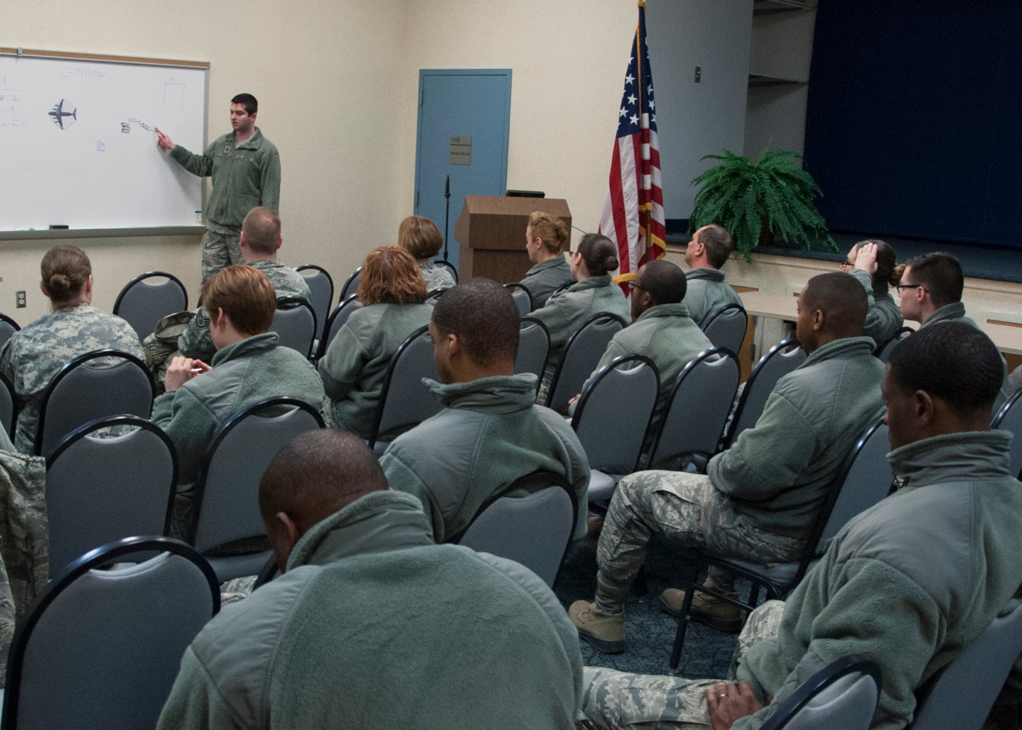 Capt. Matthew Frebert, Air Force Mortuary Affairs Operations dignified transfer officer in charge for the exercise, briefs Team Dover and New Castle Air National Guard Airmen at the start of an exercise March 19, 2015, at New Castle Air National Guard Base, Del. The training was designed to familiarize the Airmen on the DT contingency plan should one need to be conducted at the alternate location due to inclement weather during runway construction at Dover Air Force Base, Del. (U.S. Air Force photo/Senior Airman Jared Duhon)