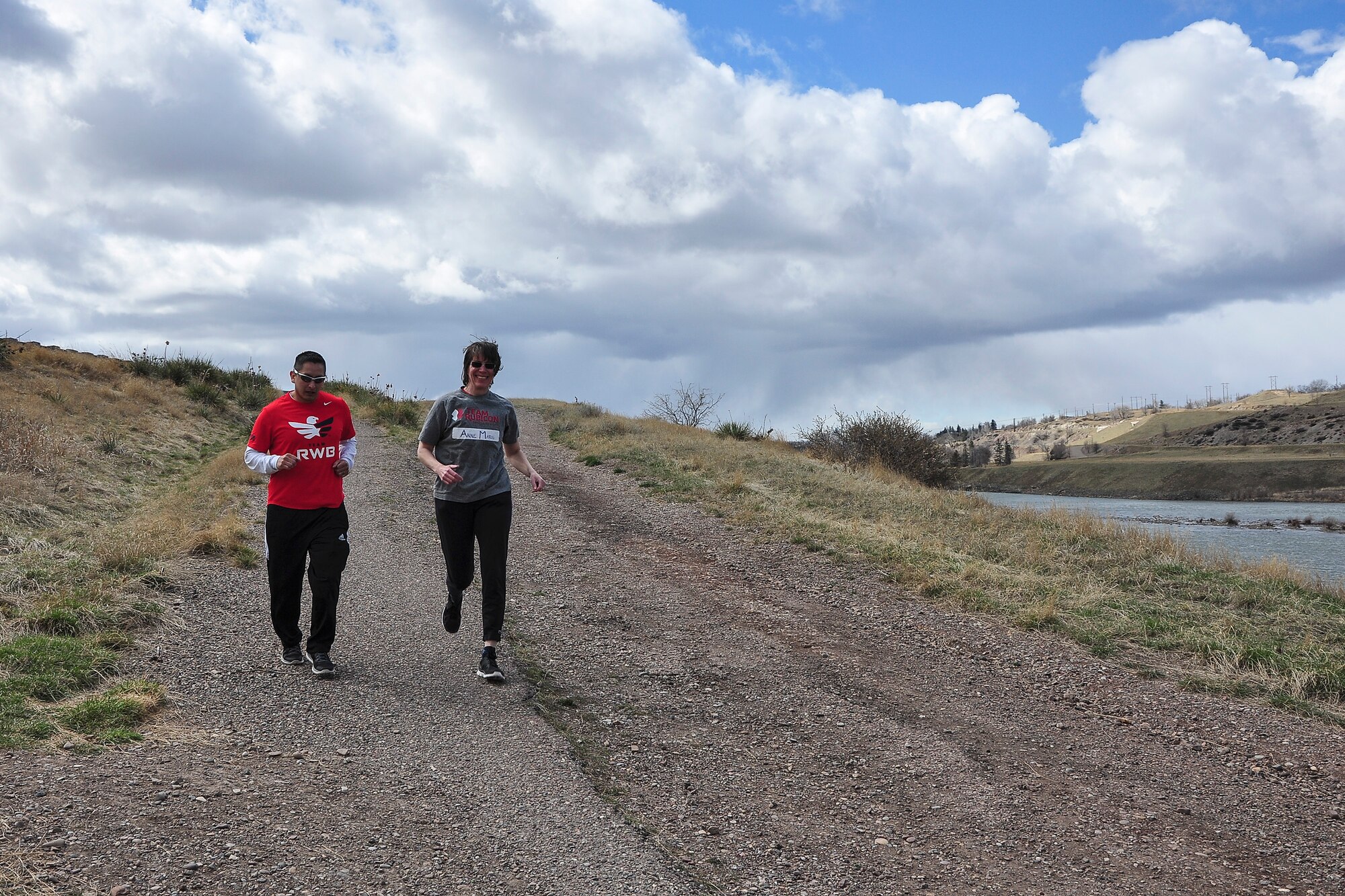 Tech. Sgt. Anthony Davalos (left), Team Red, White and Blue’s activities director, and Anne Marie Scott, Team Rubicon Region-VIII coordinator, begin the “Run as One” trail run at the Lewis and Clark overlook in Great Falls, Mont., March 28, 2015. Run as One was hosted nationwide to raise awareness and honor Marine Corps veteran Clay Hunt, an original member of Team Rubicon who took his life after battling post-traumatic stress and depression. Both organizations are designed around the idea of giving veterans a place to turn to form a lasting bond with the community and one another. (U.S. Air Force photo/Tech. Sgt. Chad Thompson)