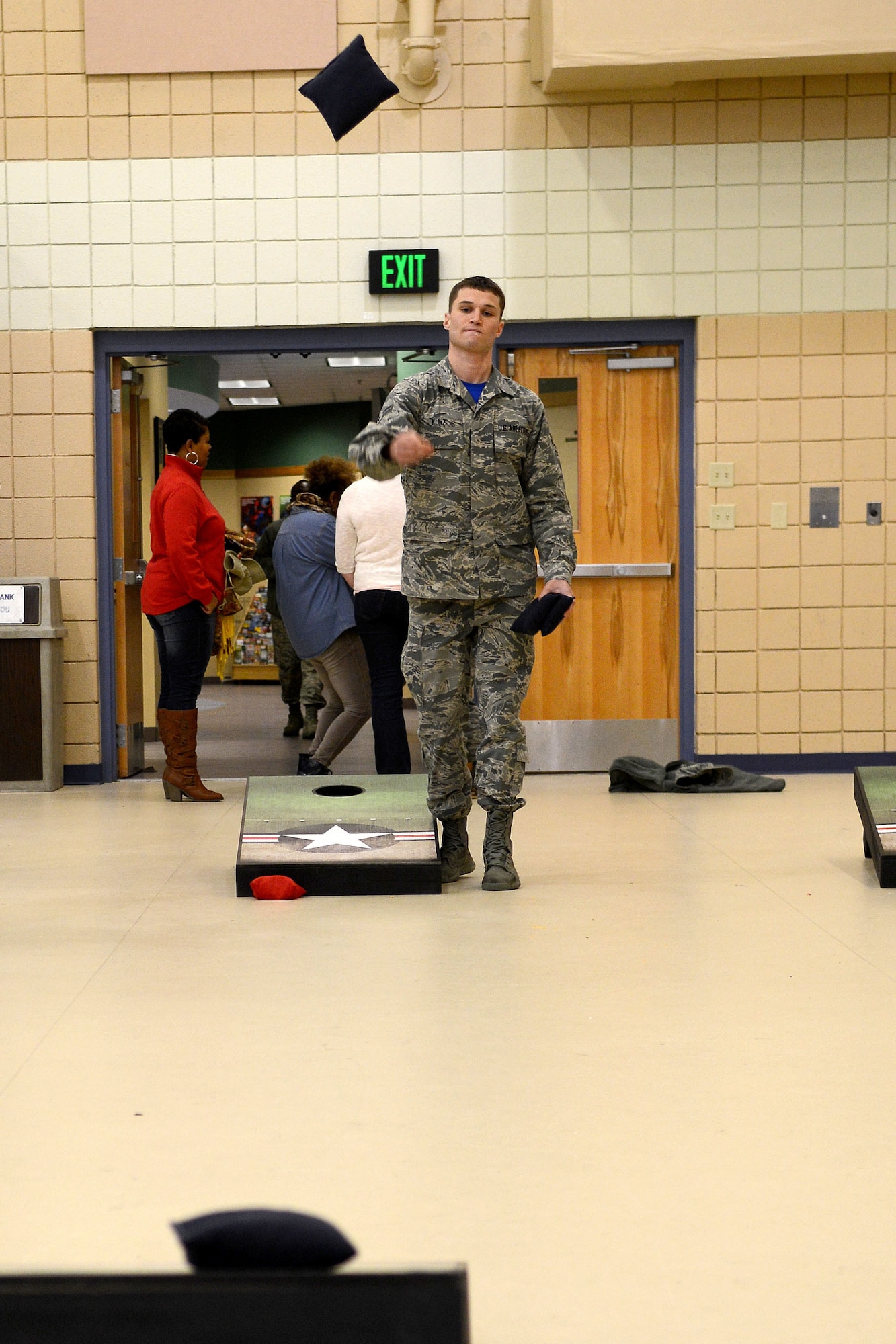U.S. Air Force Airman 1st Class Ryan Kunz, 633rd Force Support Squadron personnelist, plays corn hole during a deployment party in the Community Commons at Langley Air Force Base, Va., March 27, 2015. The party included food, drinks, table tennis, corn hole and dancing.