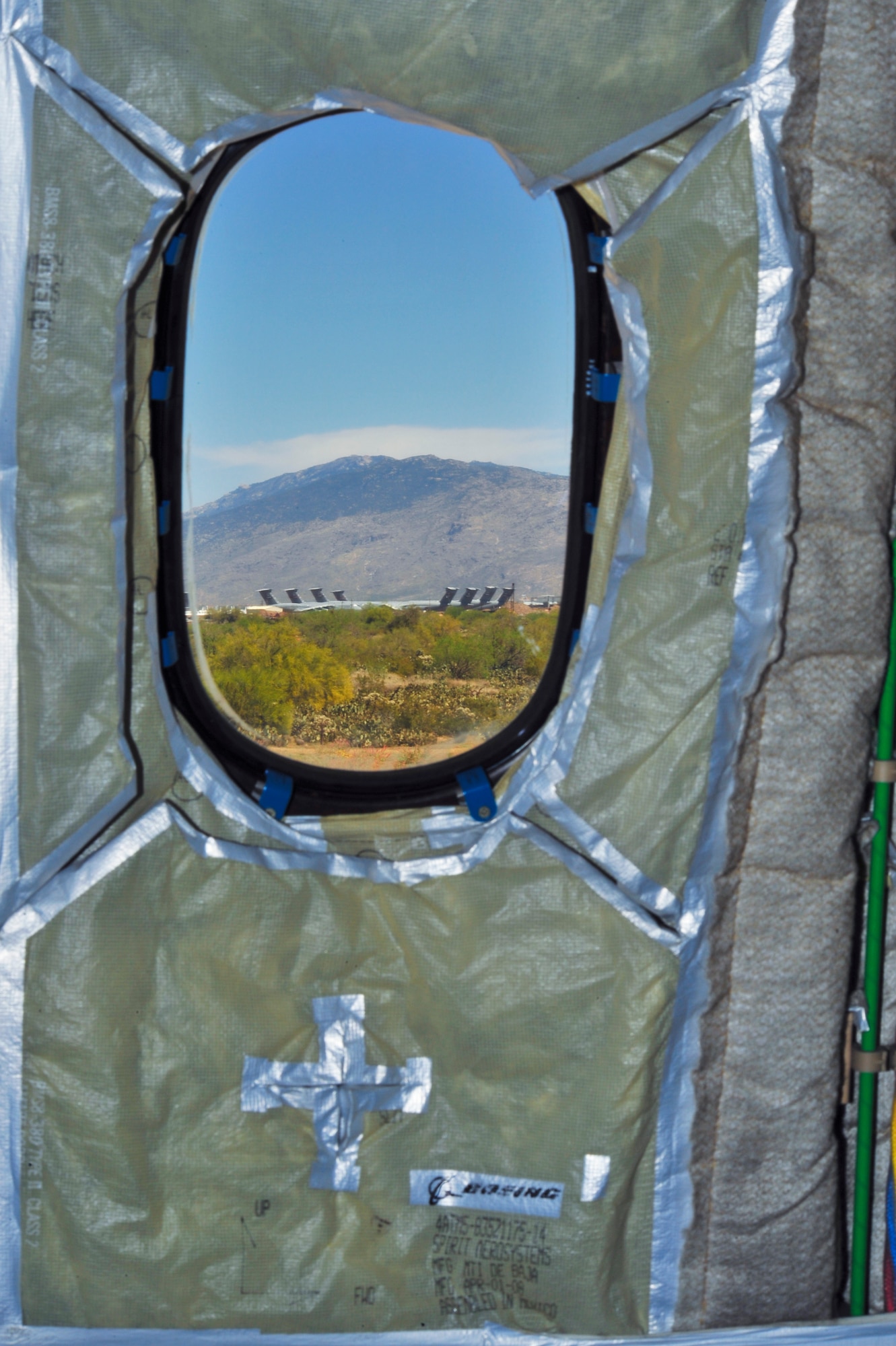 Planes at the 309th Aerospace and Maintenance Regeneration Group’s “Boneyard” can be seen through a window of a Boeing 787-8 Dreamliner while defueling at Davis-Monthan Air Force Base, Ariz., March 26, 2015.  The aircraft was transported to Pima Air and Space Museum after being donated.   (U.S. Air Force photo by Airman 1st Class Chris Massey/Released)