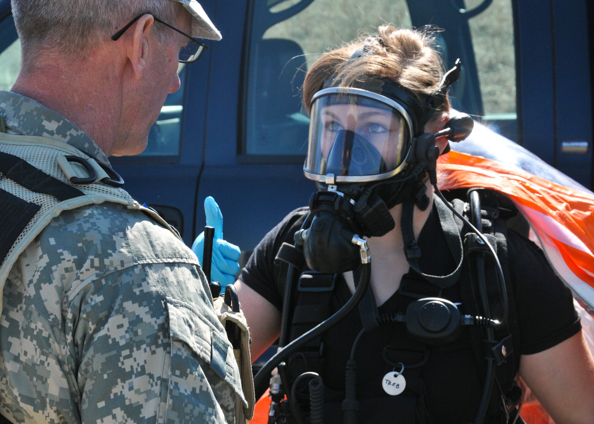 Sgt. Kelley Trebesch, 82nd Civil Support Team survey specialist, dons her protective gear before heading down range into the exercise incident area at the water reclamation plant in Sioux Falls, S.D., March 19, 2015. The survey team is known as the 'heartbeat' of the CST and goes into the contaminated area to obtain samples of potentially hazardous solids and liquids for the unit's mobile lab to analyze.(National Guard photo by Staff Sgt. Luke Olson/Released)