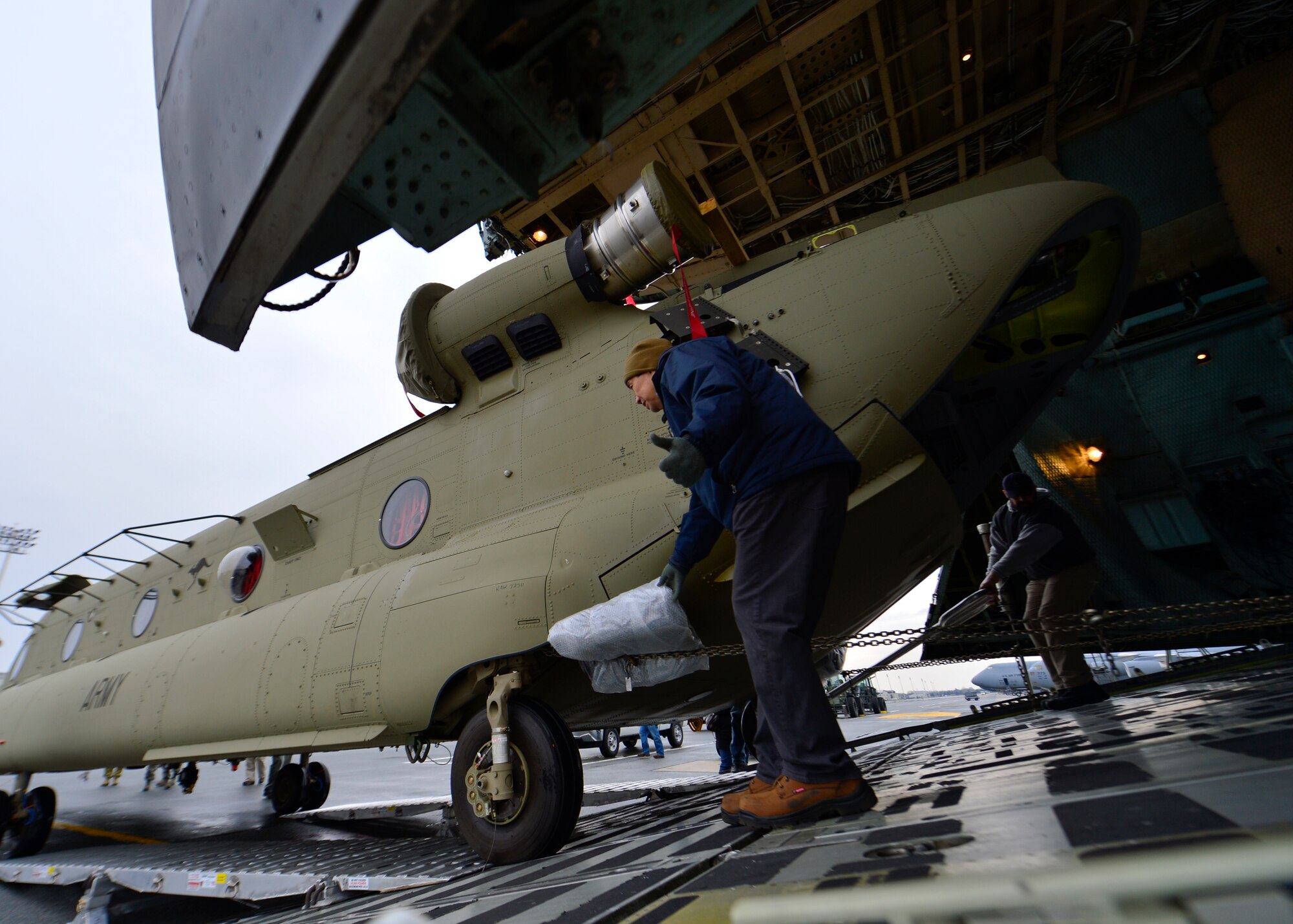 A Chinook CH-47F is loaded onto a C-5B Galaxy from the 439th Airlift Wing, Westover Air Reserve Base, Mass., March 27, 2015, at Dover Air Force Base, Del. Team Dover and the 439th AW are supporting operations to deliver two new Chinook helicopters purchased by the Australian Army. (U.S. Air Force photo/Airman 1st Class William Johnson)