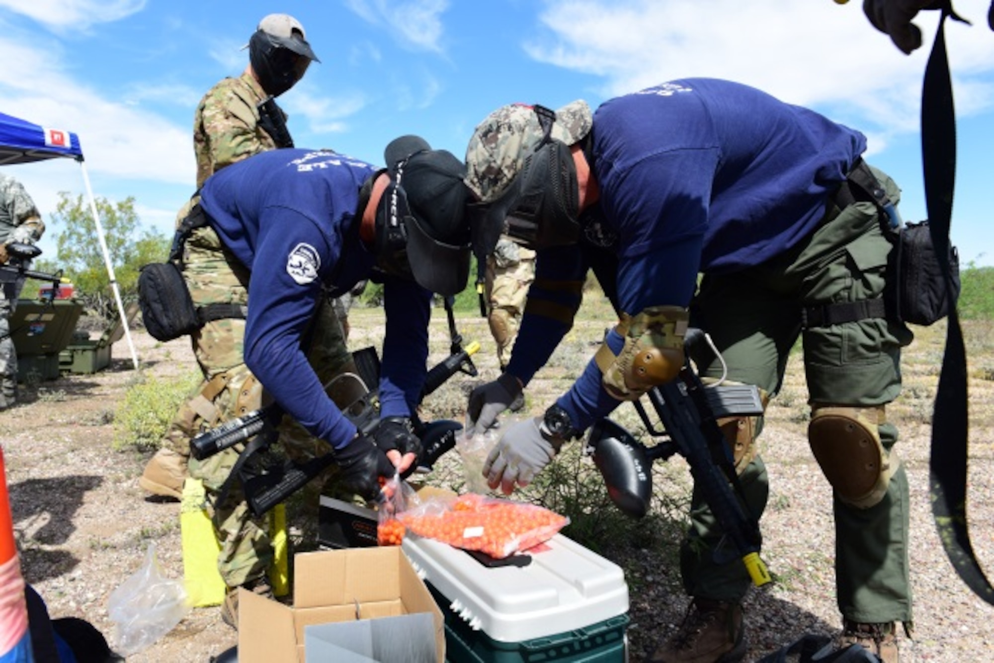 Members of the Scottsdale Fire Department and SWAT team load up on ammunition prior to starting the field exercise portion of the Tactical Combat Casualty Care course March 26 at the Luke Auxiliary Field. The four-day course was taught by the 944th Aeromedical Staging Squadron. (U.S. Air Force photo by Staff Sgt. Lausanne Kinder)
