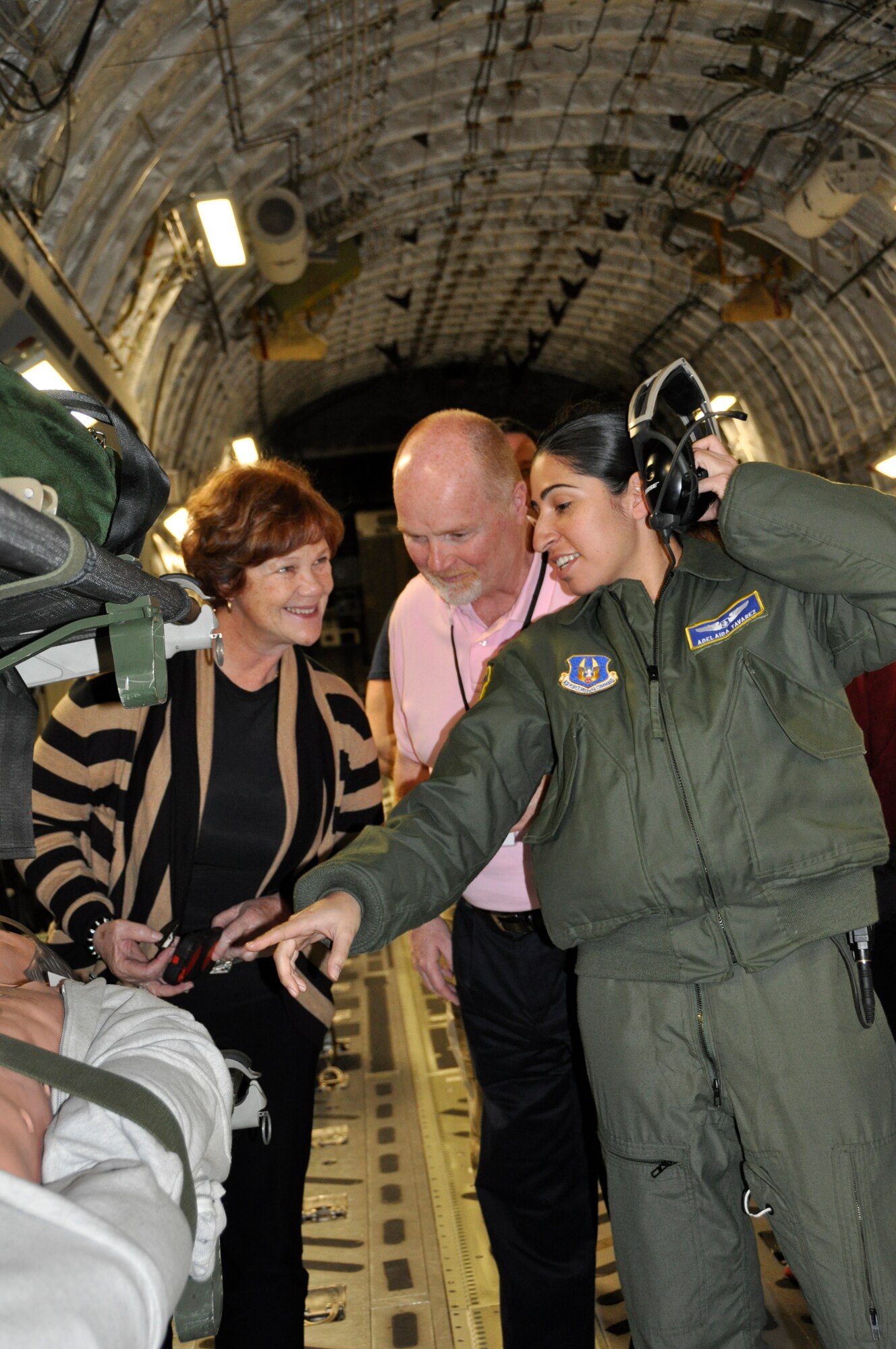 Capt. Adelaida Tavarez, 514th Aeromedical Evacuation Squadron flight nurse points out features of the dummy patient to the Col. Paulette Schank, (Ret.) and  Leslie Vail, CEO of Gloucester County Chamber of Commerce shortly after Bosslift participants boarded the C-17 Globemaster III for the return flight from Texas to Joint Base McGuire-Dix-Lakehurst, N.J., March 11. (U.S. Air Force photo/Master Sgt. Donna T. Jeffries)