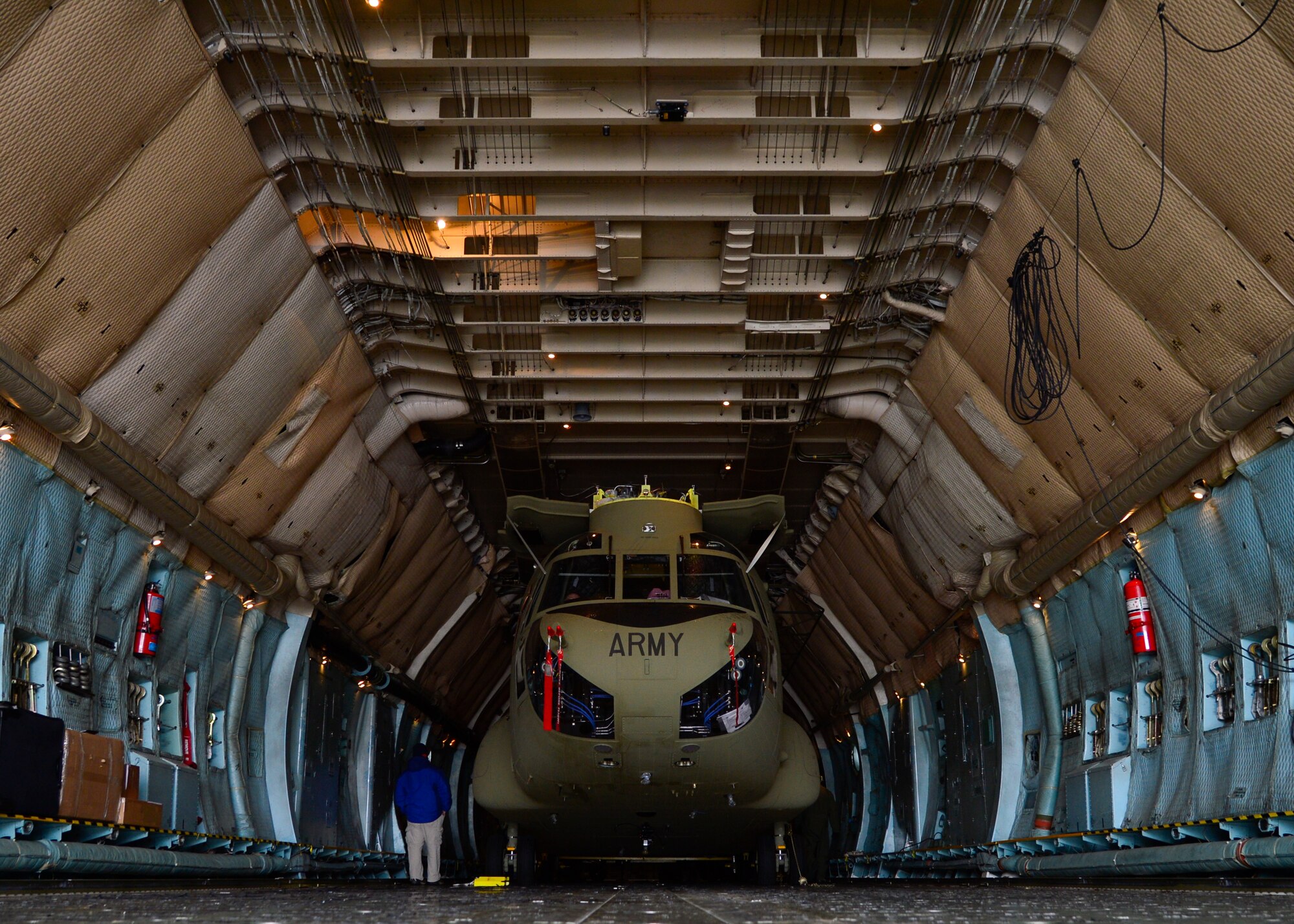 A Chinook CH-47F helicopter is loaded inside of a C-5B Galaxy from the 439th Airlift Wing, Westover Air Reserve Base, Mass., March 27, 2015, at Dover Air Force Base Del. Members of Team Dover assisted Westover ARB’s 337th Airlift Squadron in loading two Chinook helicopters into their aircraft that are headed to the Australian Army. (U.S. Air Force photo/Airman 1st Class William Johnson)