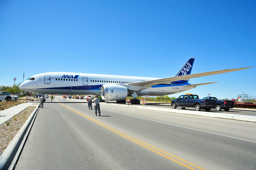 A Boeing 787-8 Dreamliner is towed across Valencia Road to the Pima Air & Space Museum after landing and defueling at Davis-Monthan Air Force Base, Ariz., March 26, 2015.  The aircraft is the first large commercial aircraft to feature an airframe made almost entirely of composite materials rather than aluminum.  (U.S. Air Force photo by Airman 1st Class Chris Massey/Released)