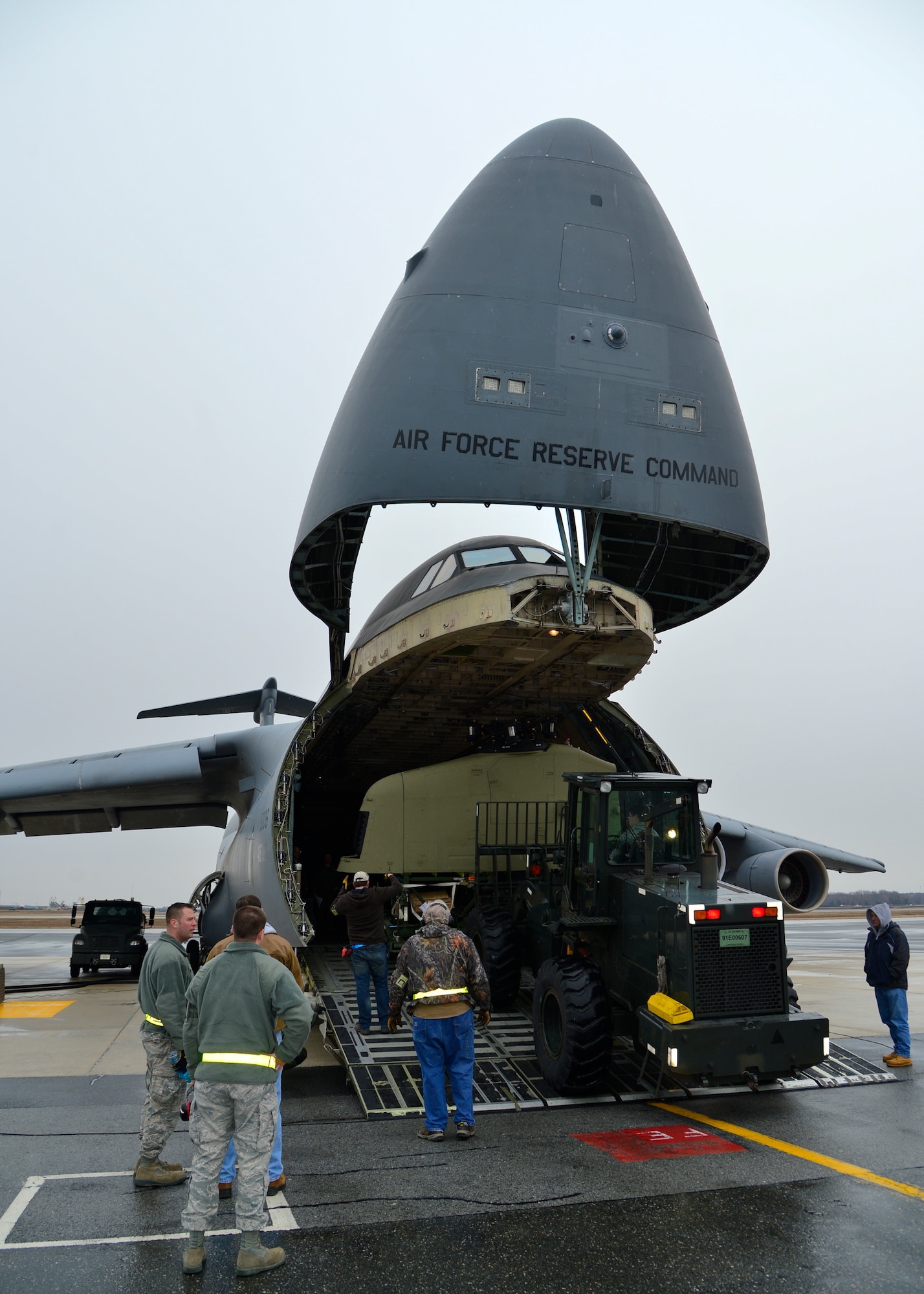 Members of Team Dover and the 337th Airlift Squadron, Westover Air Reserve Base, Mass., load the tail rotor pylon of a Chinook CH-47F helicopter into a C-5B Galaxy March 27, 2015, at Dover Air Force Base, Del. The 337th AS is delivering two Chinook CH-47F helicopters to Australia. (U.S. Air Force photo/Airman 1st Class William Johnson)