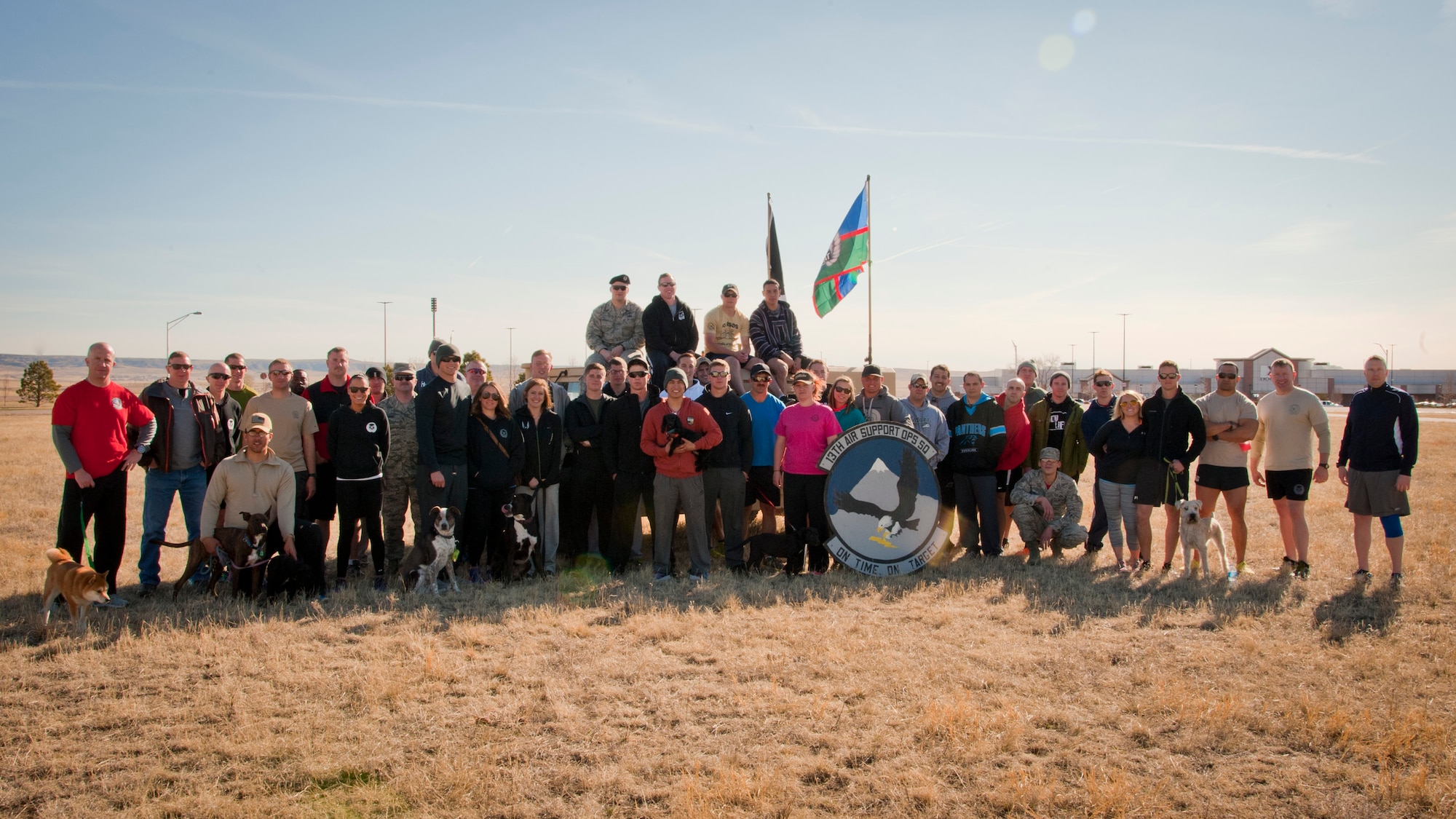 PETERSON AIR FORCE BASE, Colo. -- A group of tactical air control party Airmen from the 13th Air Support Operations Squadron and their spouses pose for a photo at the conclusion of the fourth annual 24-hour Tactical Air Control Party Awareness Run at Peak View Park on Peterson AFB, March 26. The purpose of the run was to raise awareness and generate donations for the TACP Association. The money generated by this event helps to support the families of fallen TACP members as well as disabled TACP Airmen. (U.S. Air Force photo by Staff Sgt. J. Aaron Breeden)