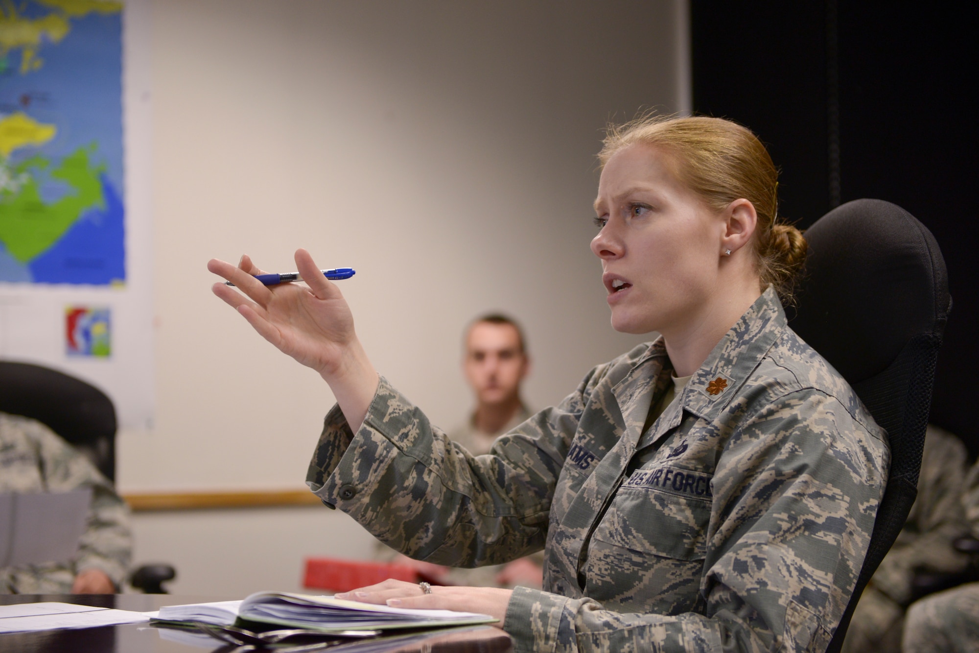 U.S. Air Force Maj. Victoria Williams, the 354th Fighter Wing senior intelligence  officer, holds a training session with her Airmen at Eielson Air Force Base, Alaska, March 26, 2015. Williams enhanced her Airmen's capability to communicate information properly to audience members. (U.S. Air Force photo by Senior Airman Peter Reft/Released)