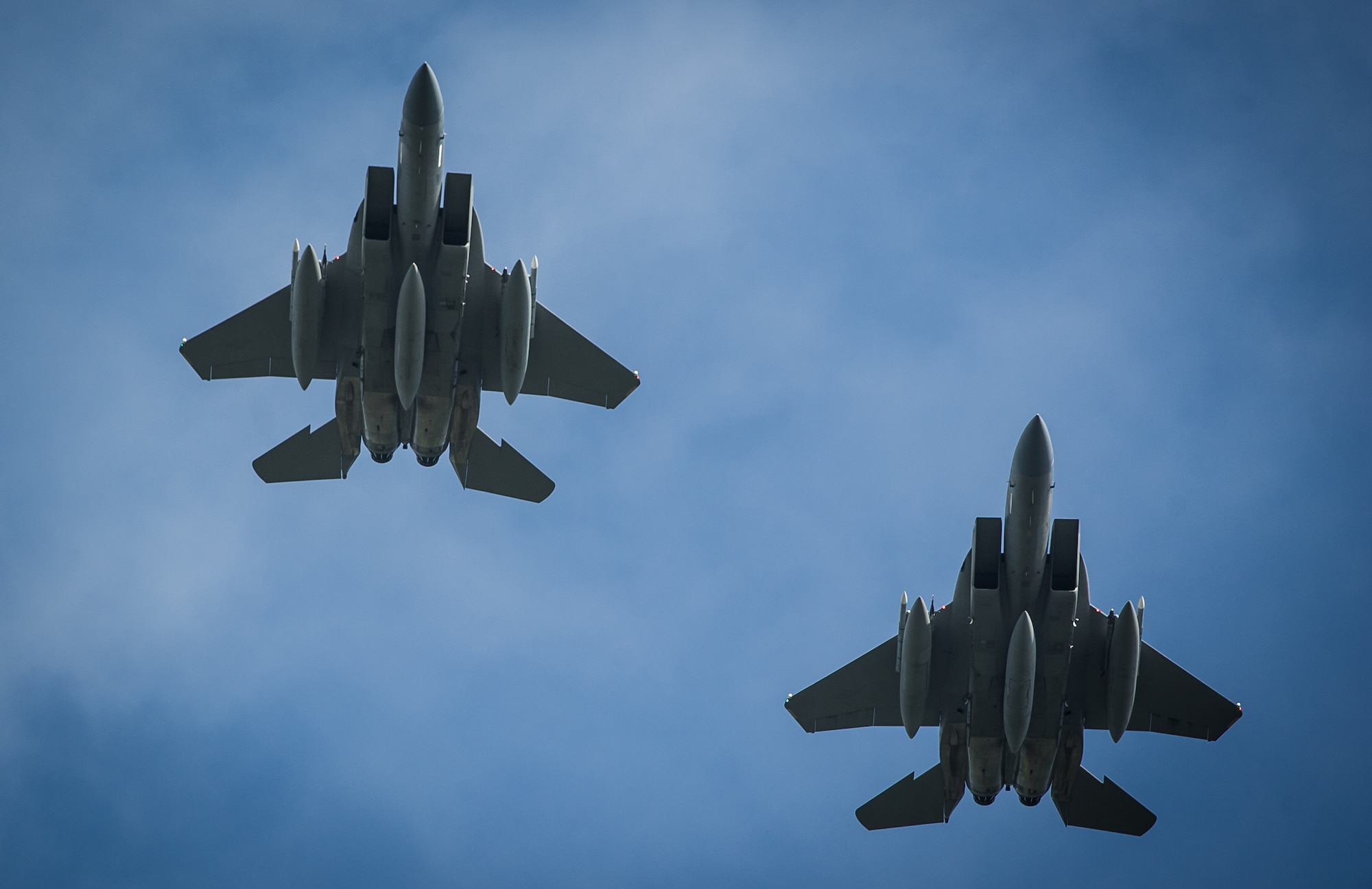 Two F-15C Eagles fly over in formation before breaking off to land at Leeuwarden Air Base, Netherlands, March 31, 2015. F-15C Eagles from the Florida Air National Guard's 159th Expeditionary Fighter Squadron are deployed to Europe as the first ever ANG theater security package here. These F-15s will conduct training alongside our NATO allies to strengthen interoperability and to demonstrate U.S. commitment to the security and stability of Europe. (U.S. Air Force photo/ Staff Sgt. Ryan Crane)