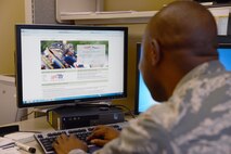 1st Lt. George Ogwela, 62nd Medical Squadron officer in charge of patient administration, logs onto Tricare Online March 18, 2015, at Joint Base Lewis-McChord, Wash. Tricare Online gives more flexibility to the patients than the hotline through features such as their appointment system, the Blue Buttton, and the Rx Refill. (U.S. Air Force photo/Airman 1st Class Keoni Chavarria)