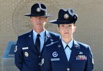 Tech. Sgt. James Mackay and his daughter Staff Sgt. Amanda Macfarlane, 433rd Training Squadron military training instructors, pose for a photo in front of the MTI monument at the parade grounds March 27, at Joint Base San Antonio-Lackland. Mackay and Macfarlane are the first father and daughter duo serving as MTIs at the same time. (U.S. Air Force photo by Benjamin Faske/released)