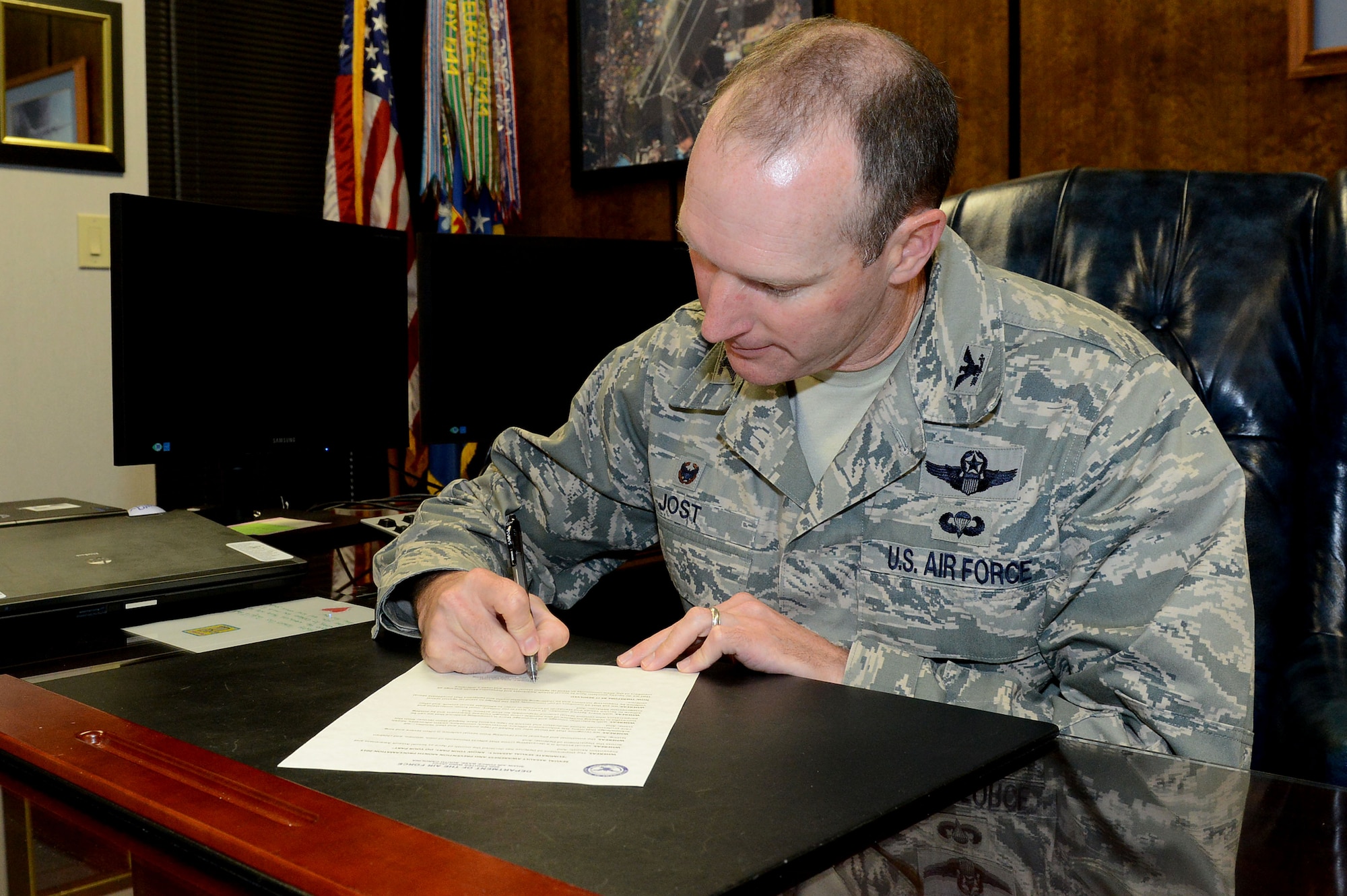U.S. Air Force Col. Stephen Jost, 20th Fighter Wing commander, signs a proclamation stating the start of Sexual Assault Awareness and Prevention Month at Shaw Air Force Base, S.C., March 23, 2015. The proclamation asks all members of the Team Shaw community to take a pledge to stand up against sexual violence by supporting survivors and challenging societal myths and behaviors that perpetuate sexual violence. (U.S. Air Force photo by Senior Airman Diana M. Cossaboom/Released)